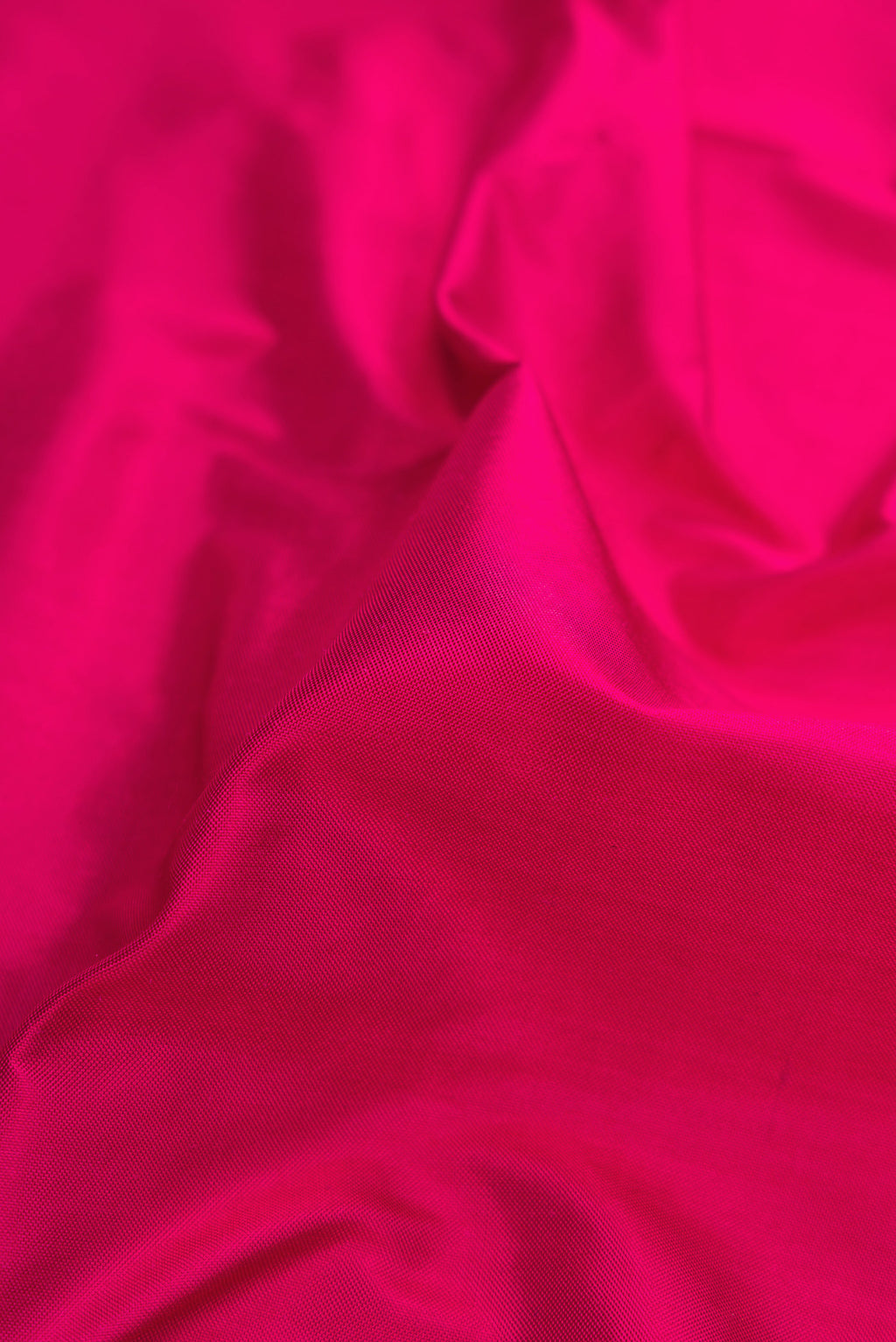 Close up of Dark Pink Dual Tone Double Ikat Saree with Plain Body and Fancy Border.  displaying folds