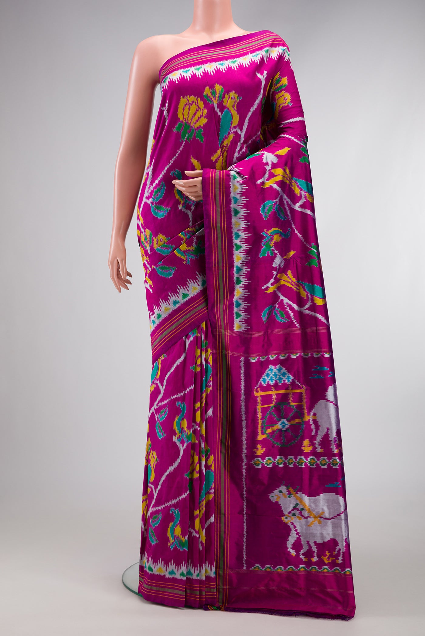 Magenta Dual Tone Double Ikat Saree with Ikat Print on the body and Ikat Border.  displayed on a mannequin