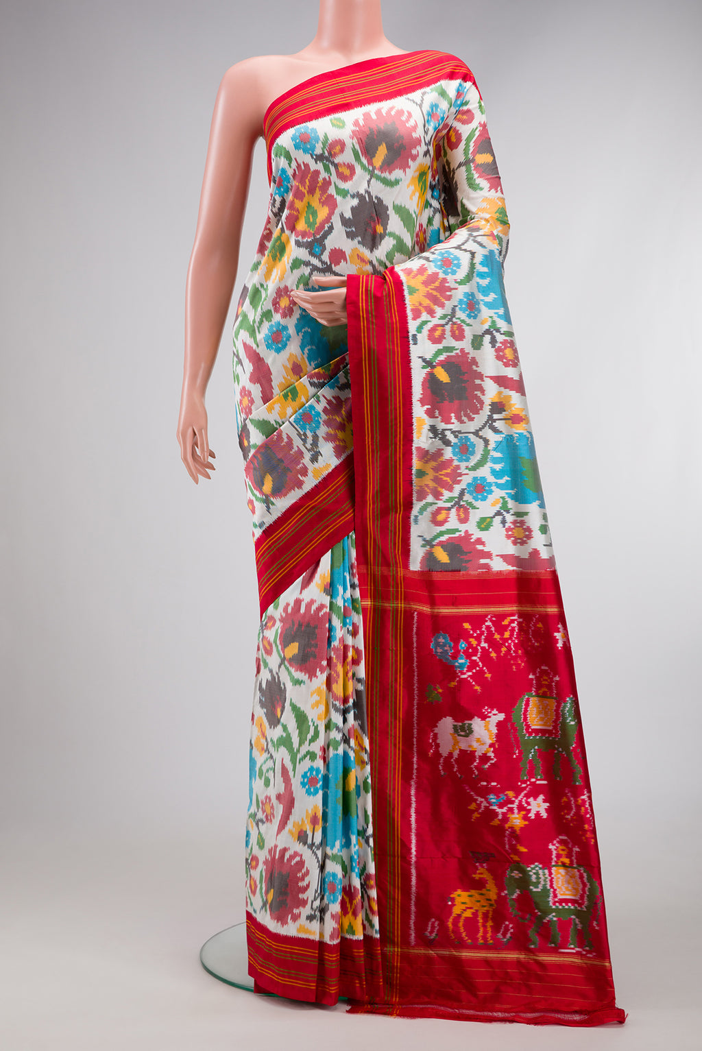 White Dual Tone Double Ikat Saree with Ikat Print on the body and Thread Border.  displayed on a mannequin
