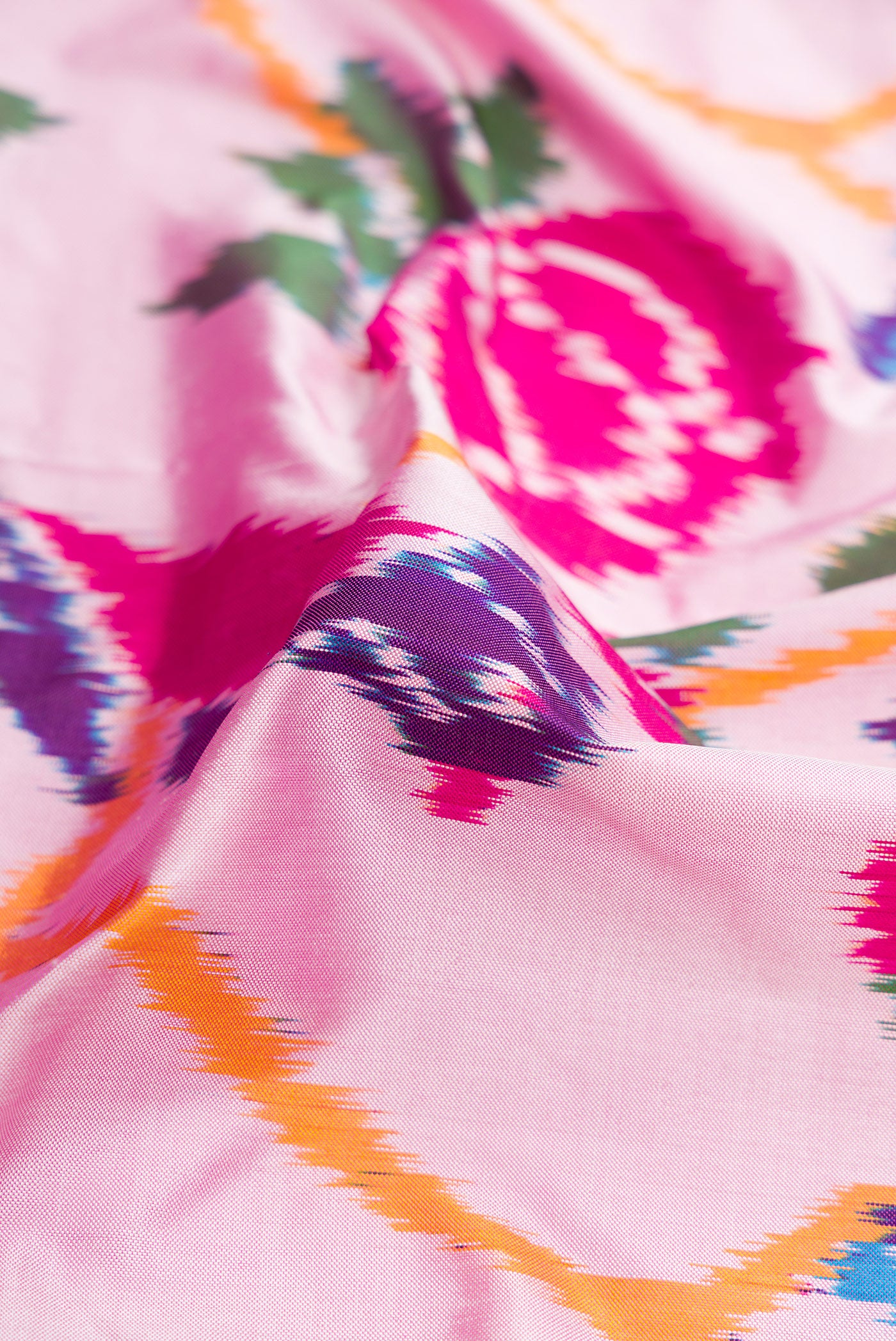 Close up of Pink Dual Tone Double Ikat Saree with Ikat Print on the body and Ikat Border.  displaying folds