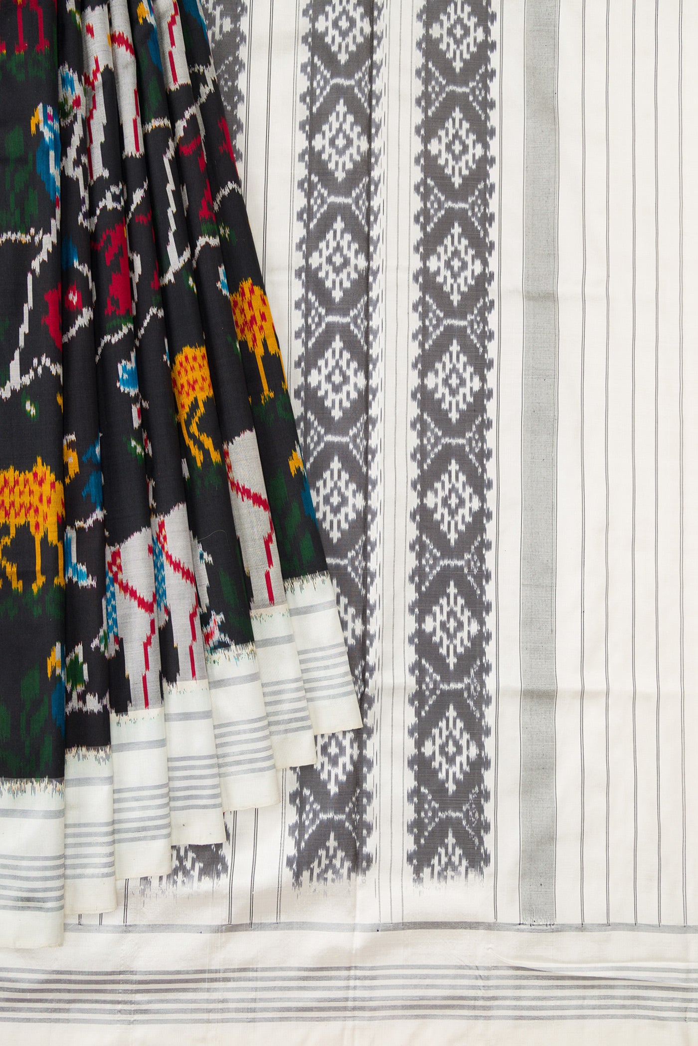 Pleats and pallu of Black Dual Tone Double Ikat Saree with Ikat Print on the body and Thread Border. 