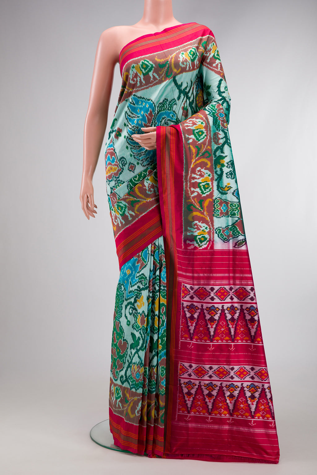 Pista Green Dual Tone Double Ikat Saree with Ikat Print on the body and Ikat Border.  displayed on a mannequin