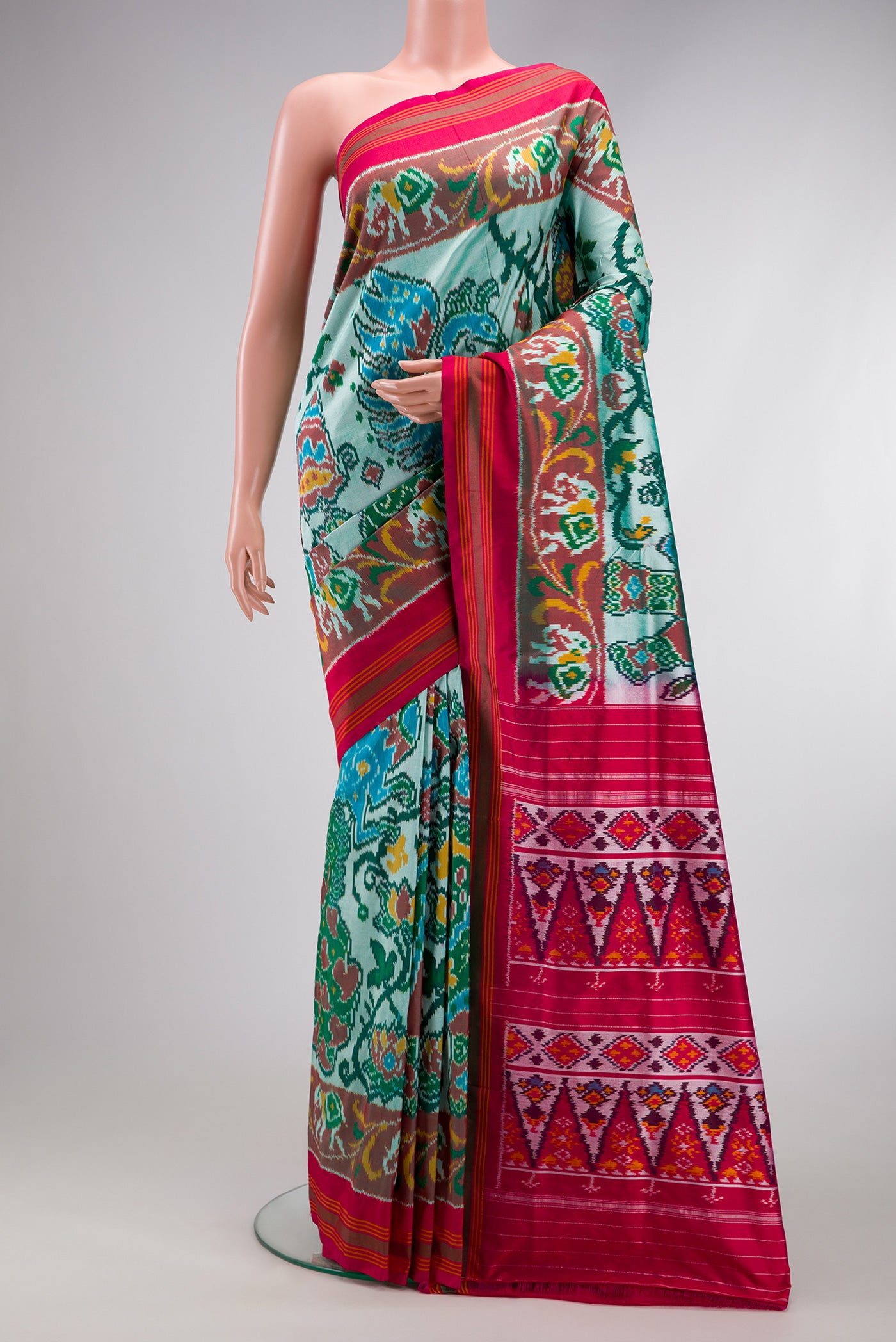 Pista Green Dual Tone Double Ikat Saree with Ikat Print on the body and Ikat Border.  displayed on a mannequin