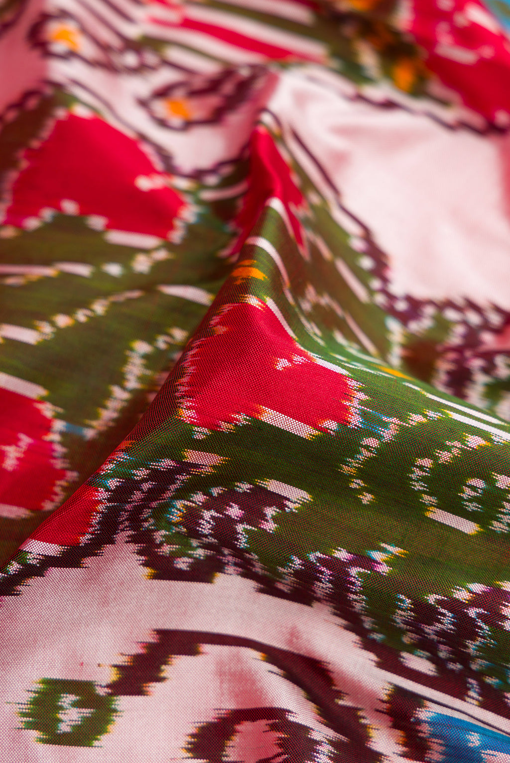 Close up of Mustard Dual Tone Double Ikat Saree with Ikat Print on the body and Ikat Border.  displaying folds
