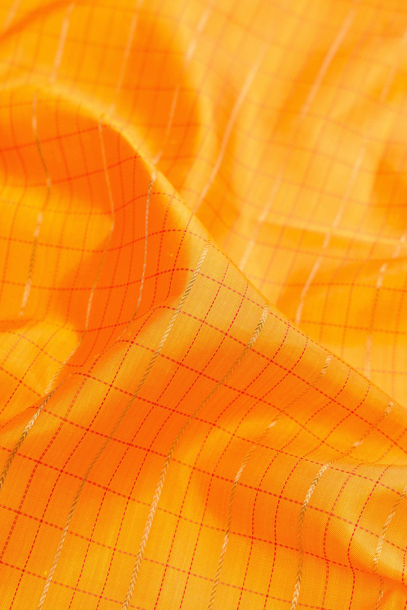 Close up of Pure Silk Pure Zari Mustard Dual Tone Kanchipuram Saree with Checked design on the body and Fancy Border.  displaying folds