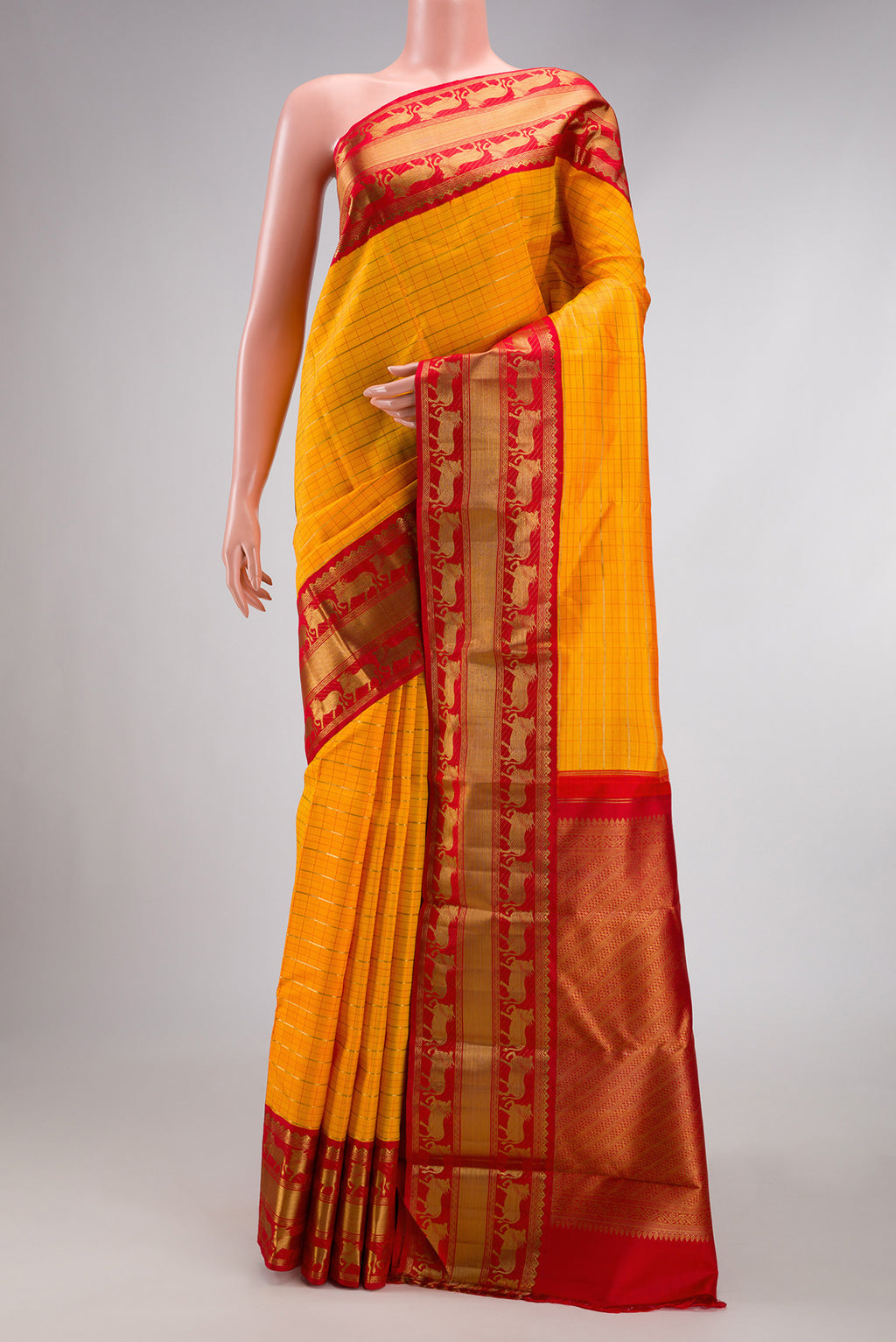 Pure Silk Pure Zari Mustard Dual Tone Kanchipuram Saree with Checked design on the body and Fancy Border.  displayed on a mannequin