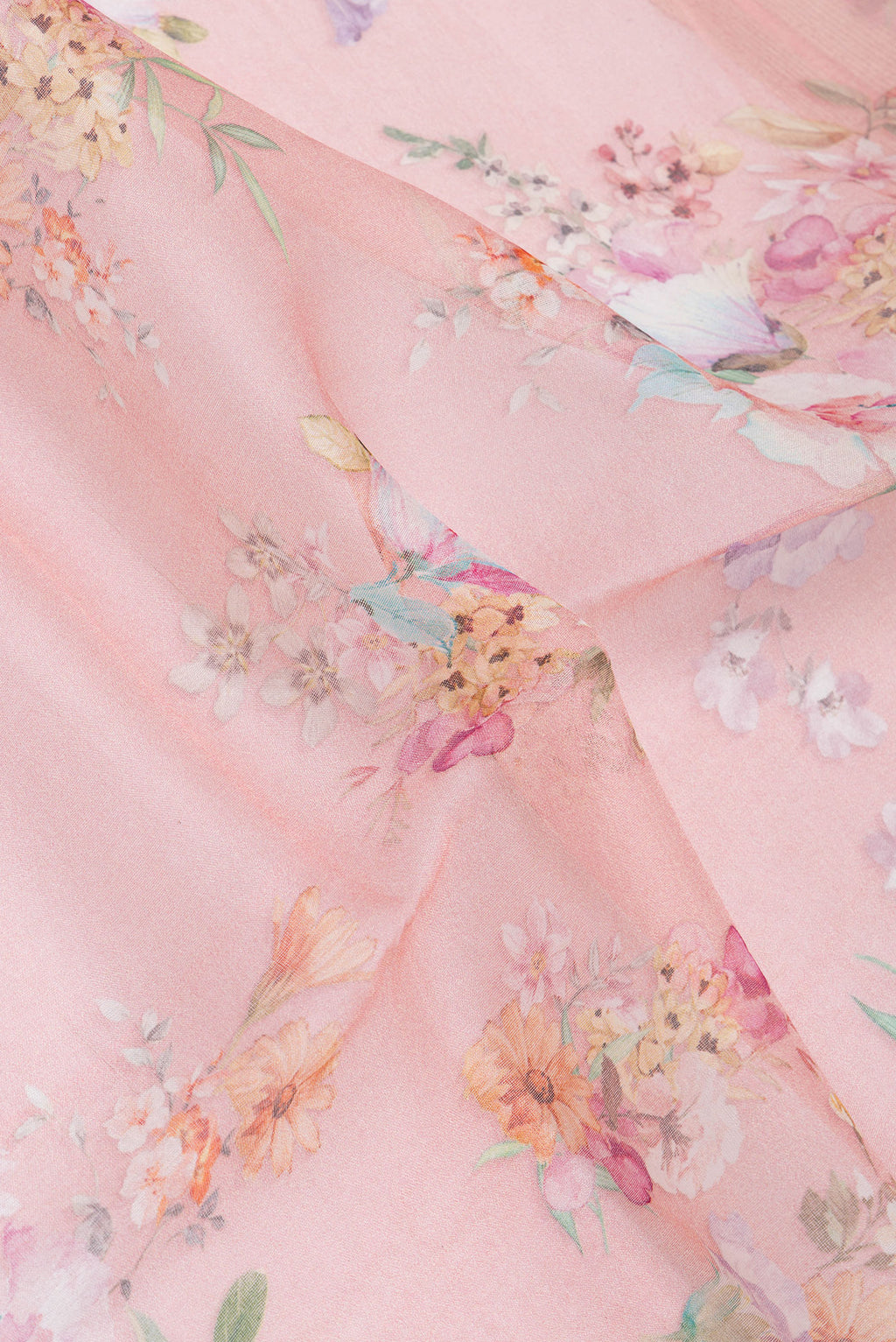 Close up of Golden Peach Organza Silk Saree with Printed design on the body and Zari Border.  displaying folds
