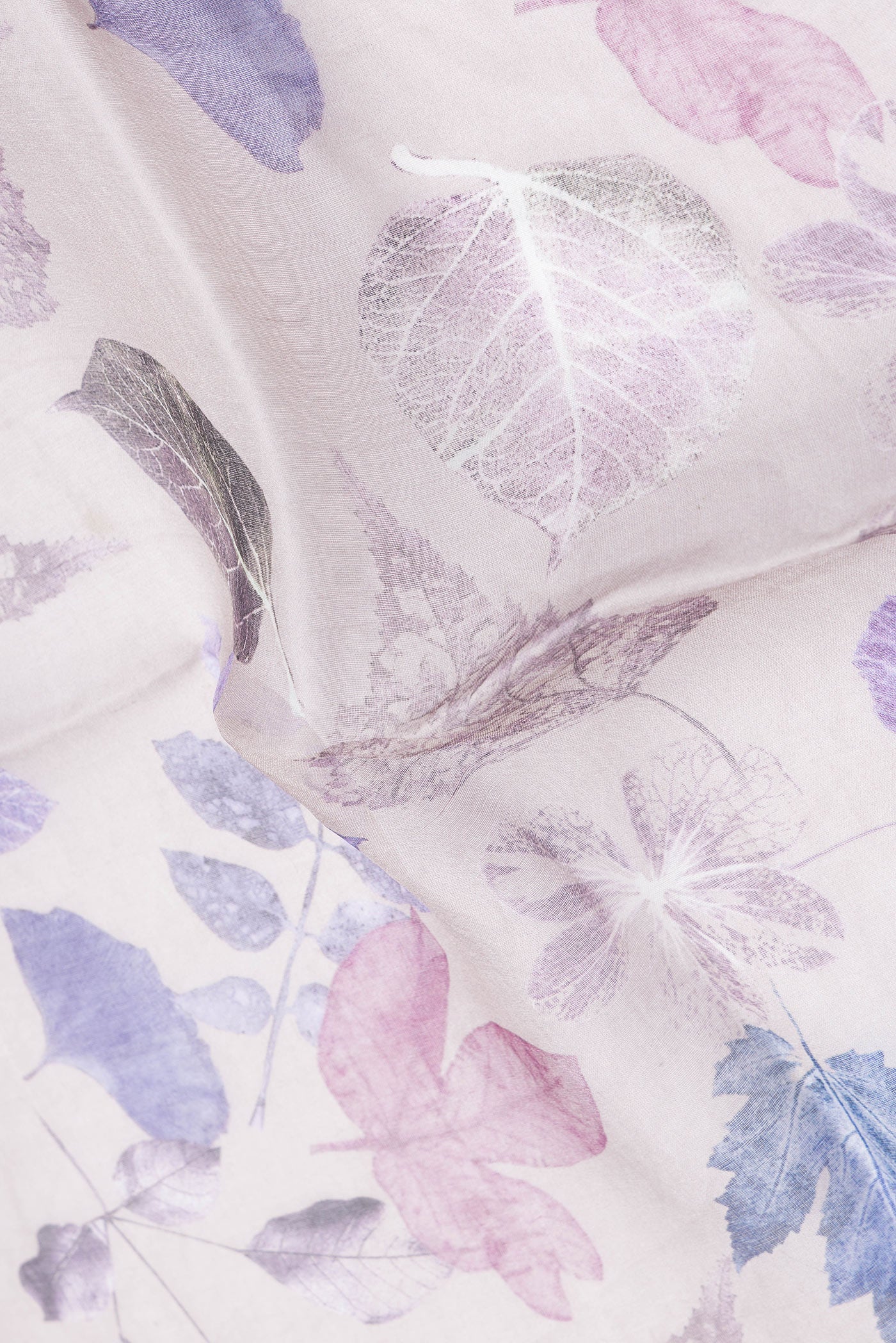 Close up of Grey Dual Tone Tussar Silk Saree with Printed design on the body and Zari Border.  displaying folds