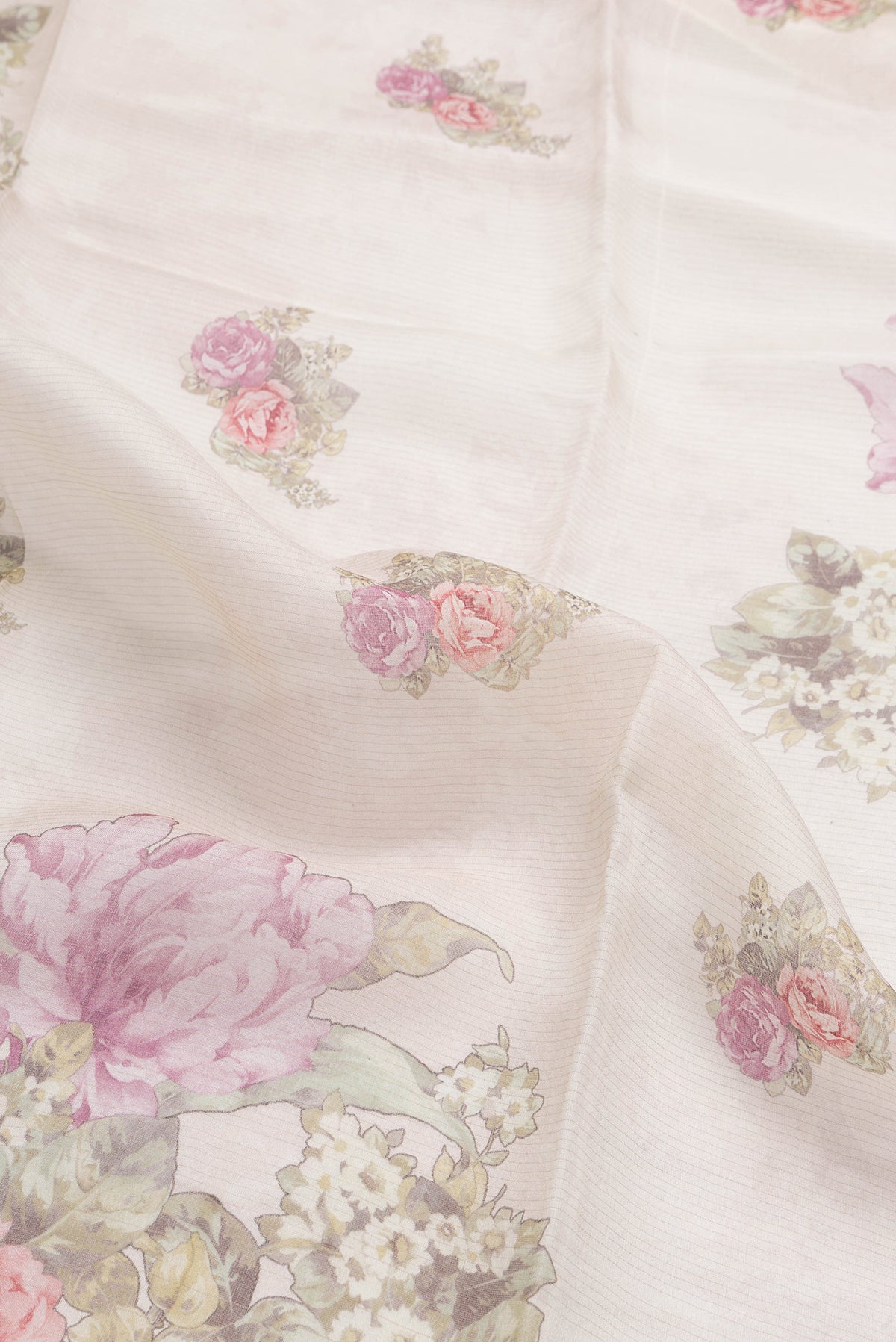 Close up of Beige Dual Tone Tussar Silk Saree with Printed design on the body and Zari Border.  displaying folds