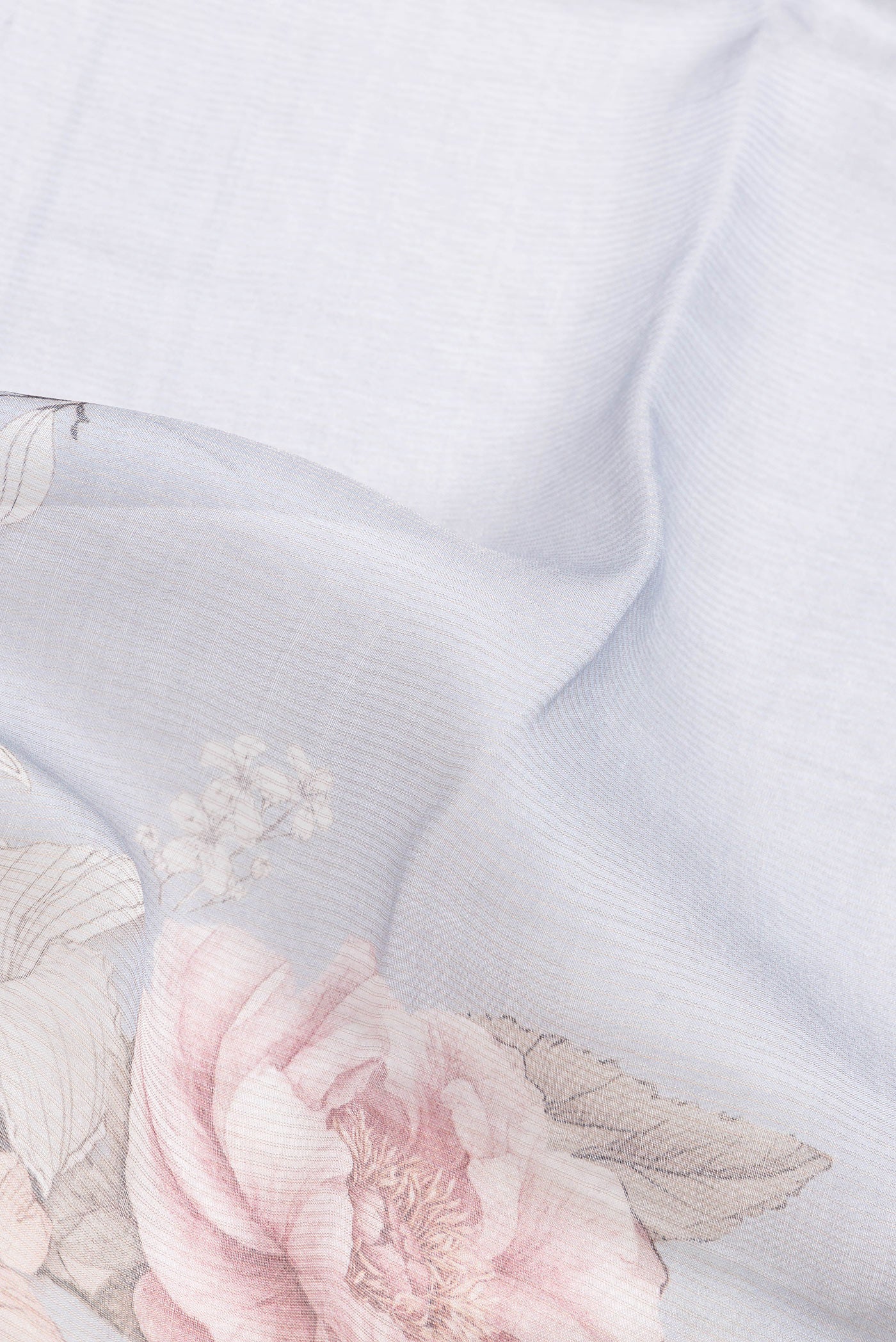 Close up of Grey Dual Tone Tussar Silk Saree with Printed design on the body and Embroidery Border.  displaying folds