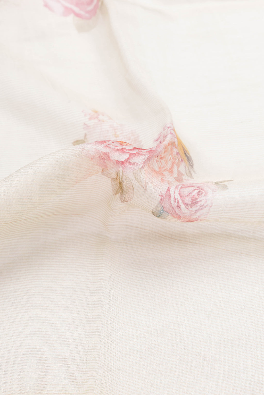 Close up of Beige Dual Tone Tussar Silk Saree with Printed design on the body and Printed Border.  displaying folds
