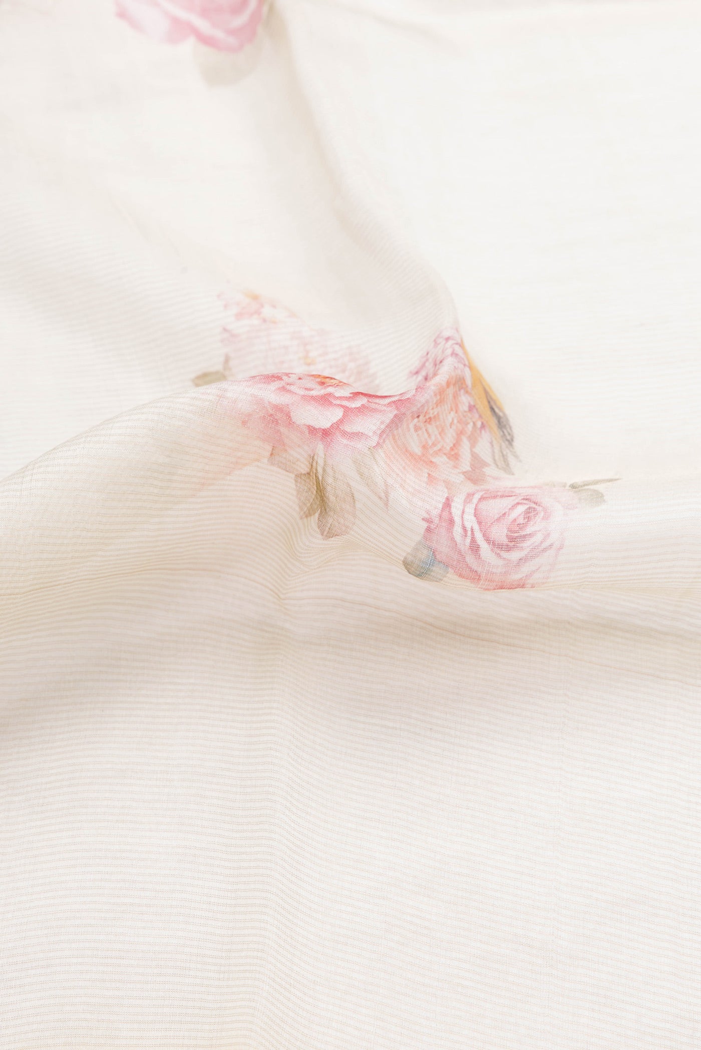 Close up of Beige Dual Tone Tussar Silk Saree with Printed design on the body and Printed Border.  displaying folds