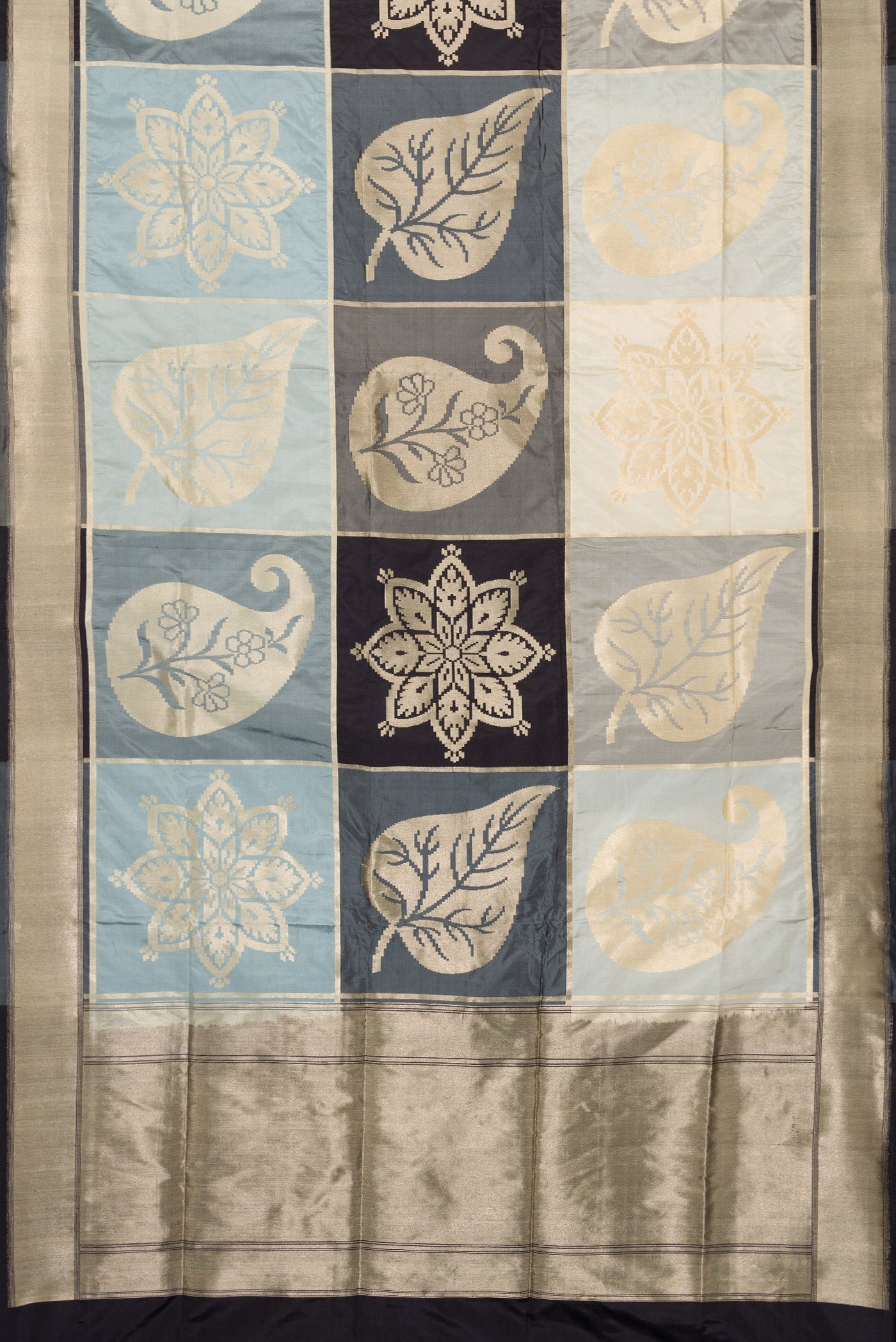 Flat view of Black, Grey and Off White Color Banarasi Silk Saree with Zari Brocade on the body and Zari Border. 