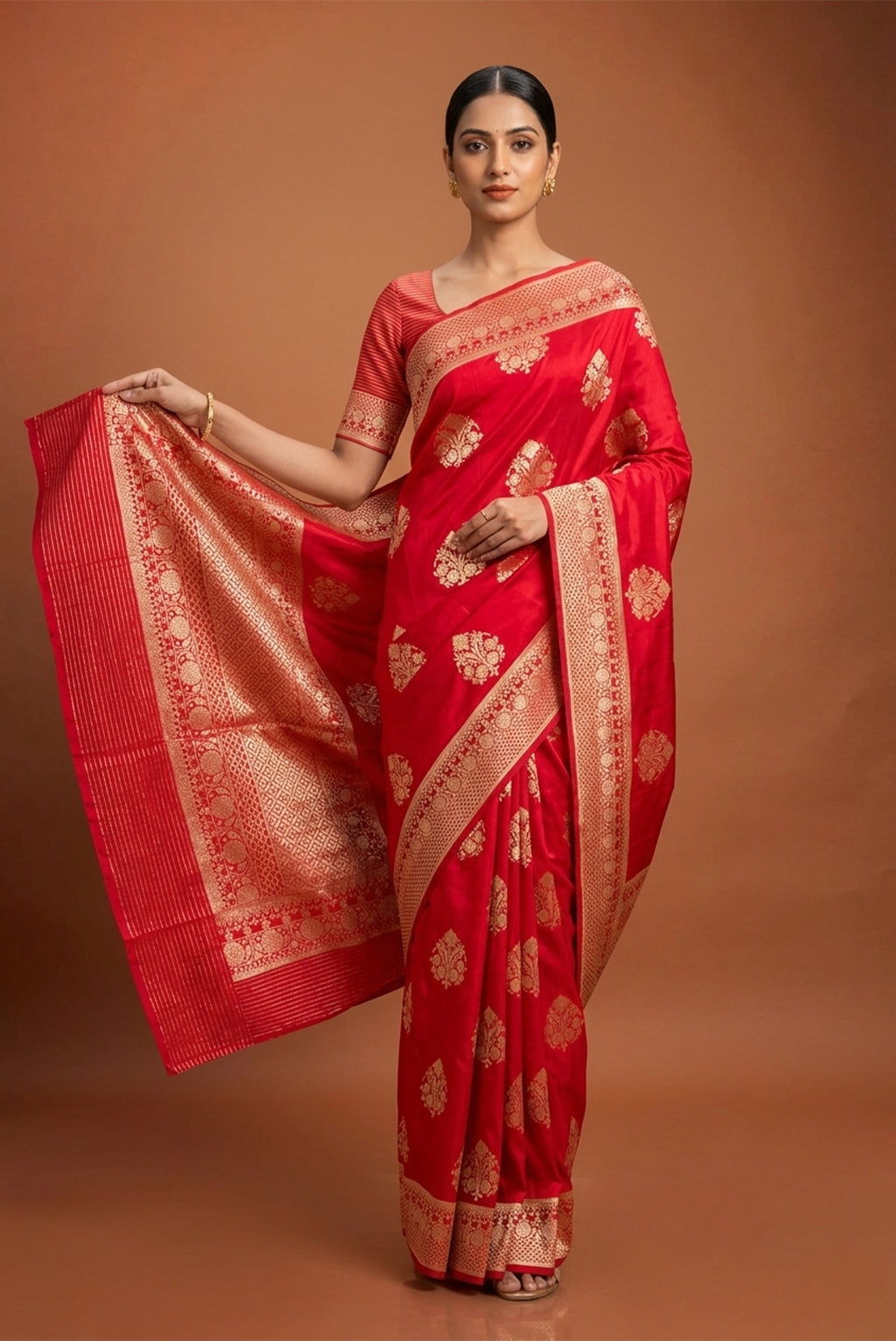 Model wearing a Red Banarasi Silk Saree with Zari And Thread Butta on the body and Zari Border.