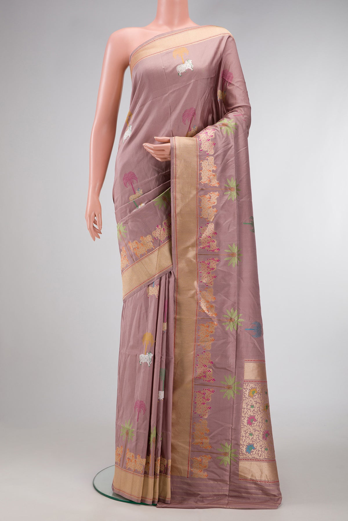 Rose Gold Dual Tone Banarasi Silk Saree with Zari And Thread Butta on the body and Fancy Border.  displayed on a mannequin