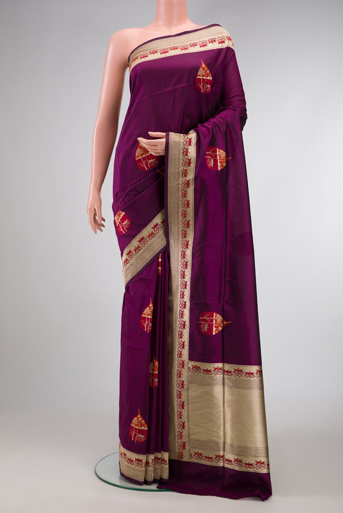 Burgundy Dual Tone Banarasi Silk Saree with Zari And Thread Butta on the body and Fancy Border.  displayed on a mannequin