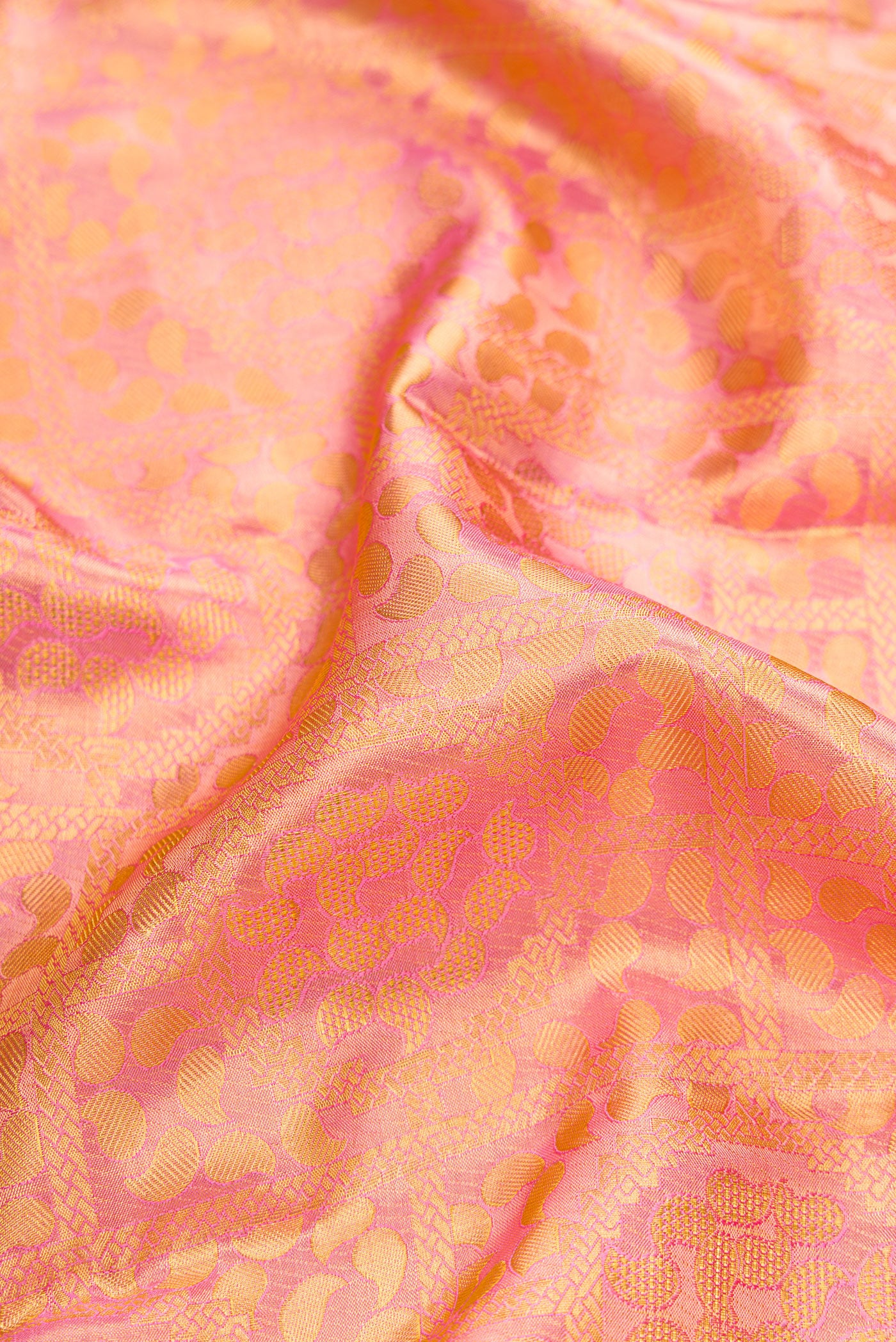 Close up of Rose pink Dual Tone Kanchipuram Tissue Silk Saree with Zari Brocade on the body and Zari Border.  displaying folds