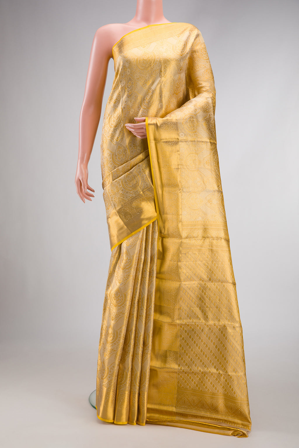 Gold Dual Tone Kanchipuram Tissue Silk Saree with Zari Brocade on the body and Zari Border.  displayed on a mannequin