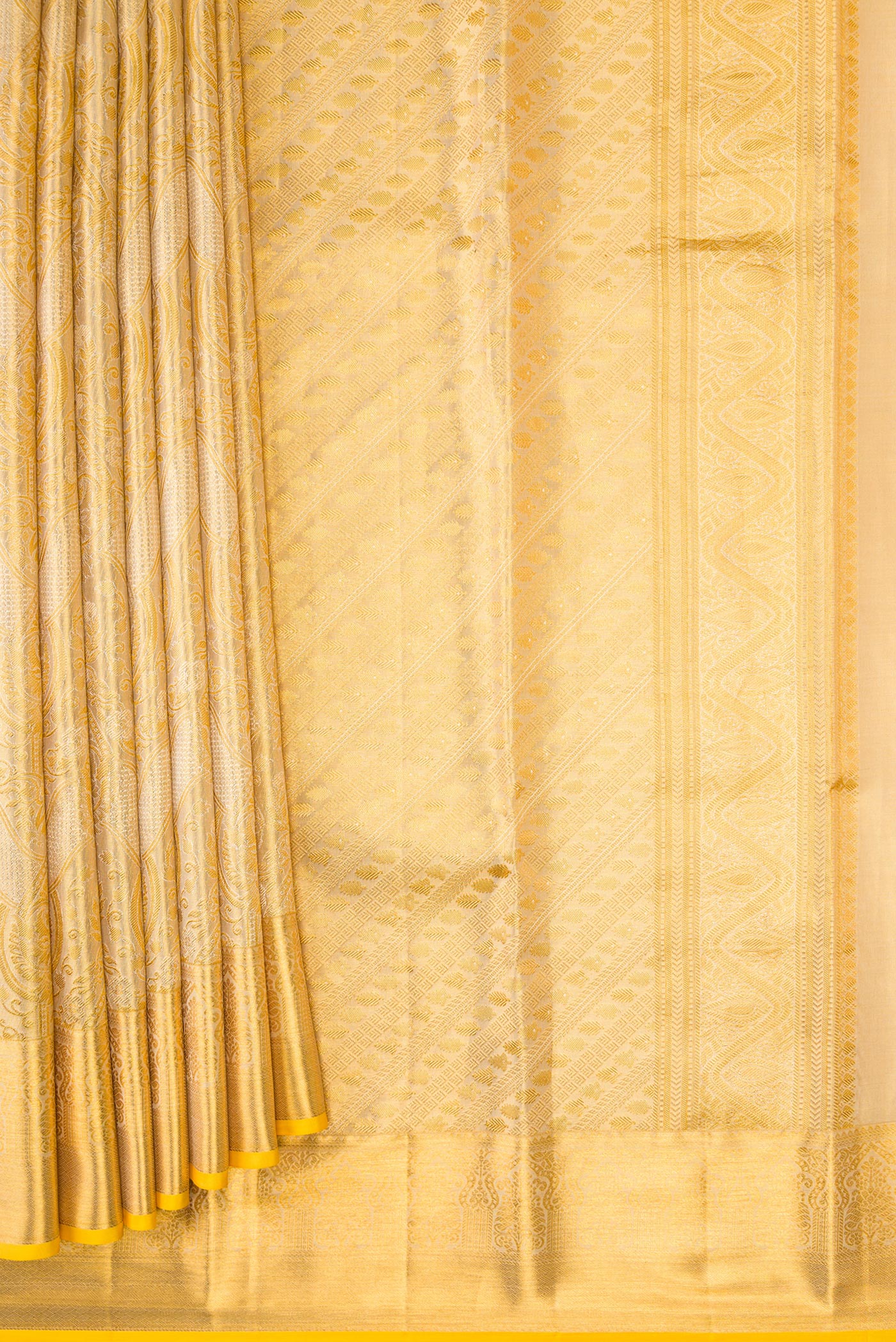 Pleats and pallu of Gold Dual Tone Kanchipuram Tissue Silk Saree with Zari Brocade on the body and Zari Border. 