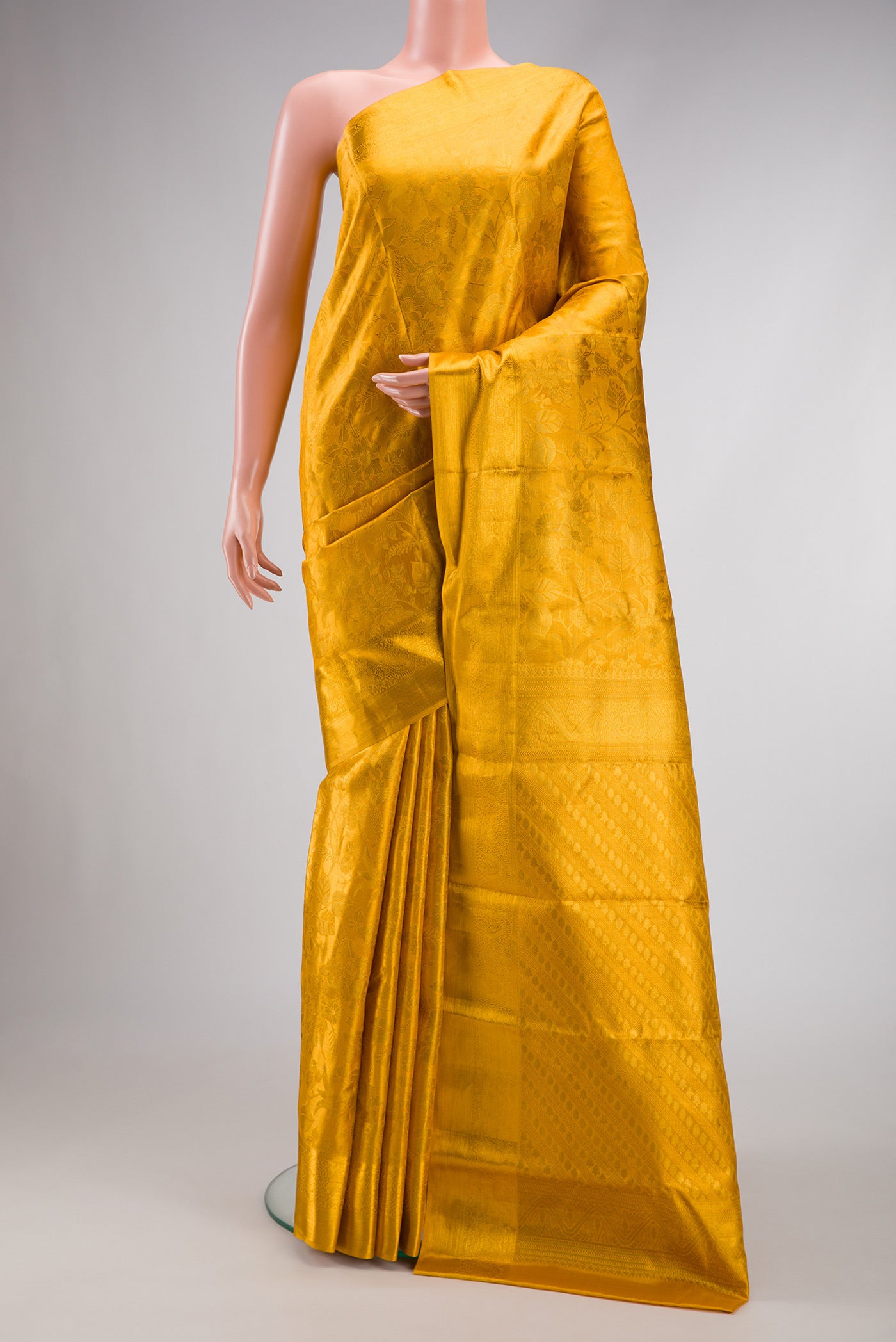 Gold Dual Tone Kanchipuram Tissue Silk Saree with Zari Brocade on the body and Zari Border.  displayed on a mannequin