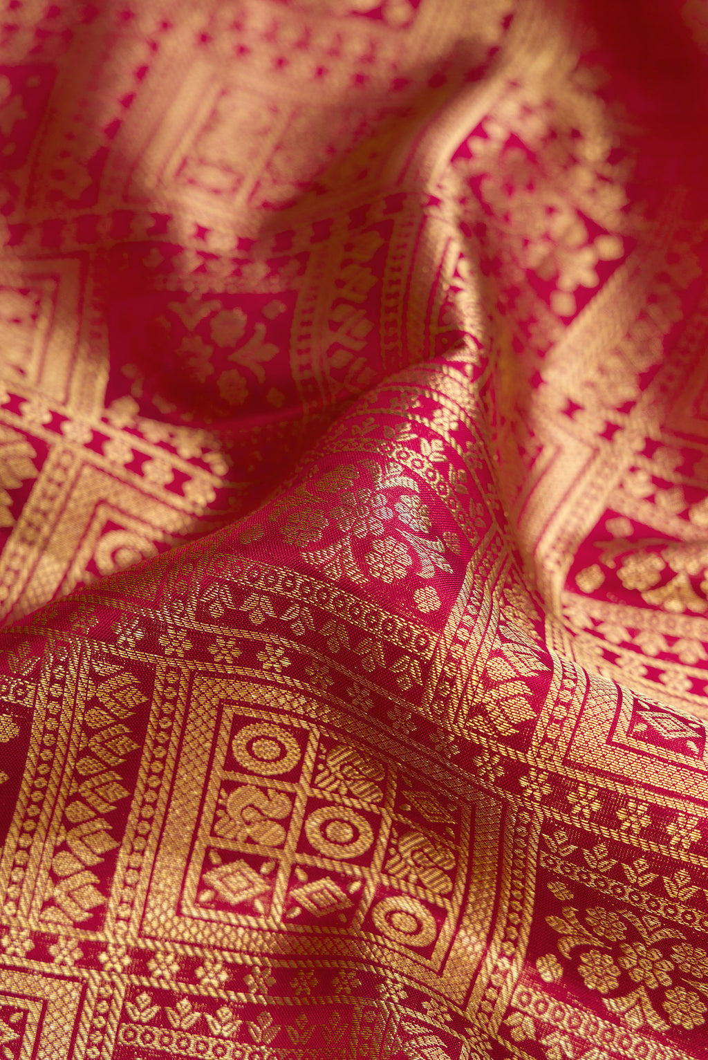 Close up of Maroon Kanjivaram Silk Saree with Zari Brocade on the body and Zari Border.  displaying folds