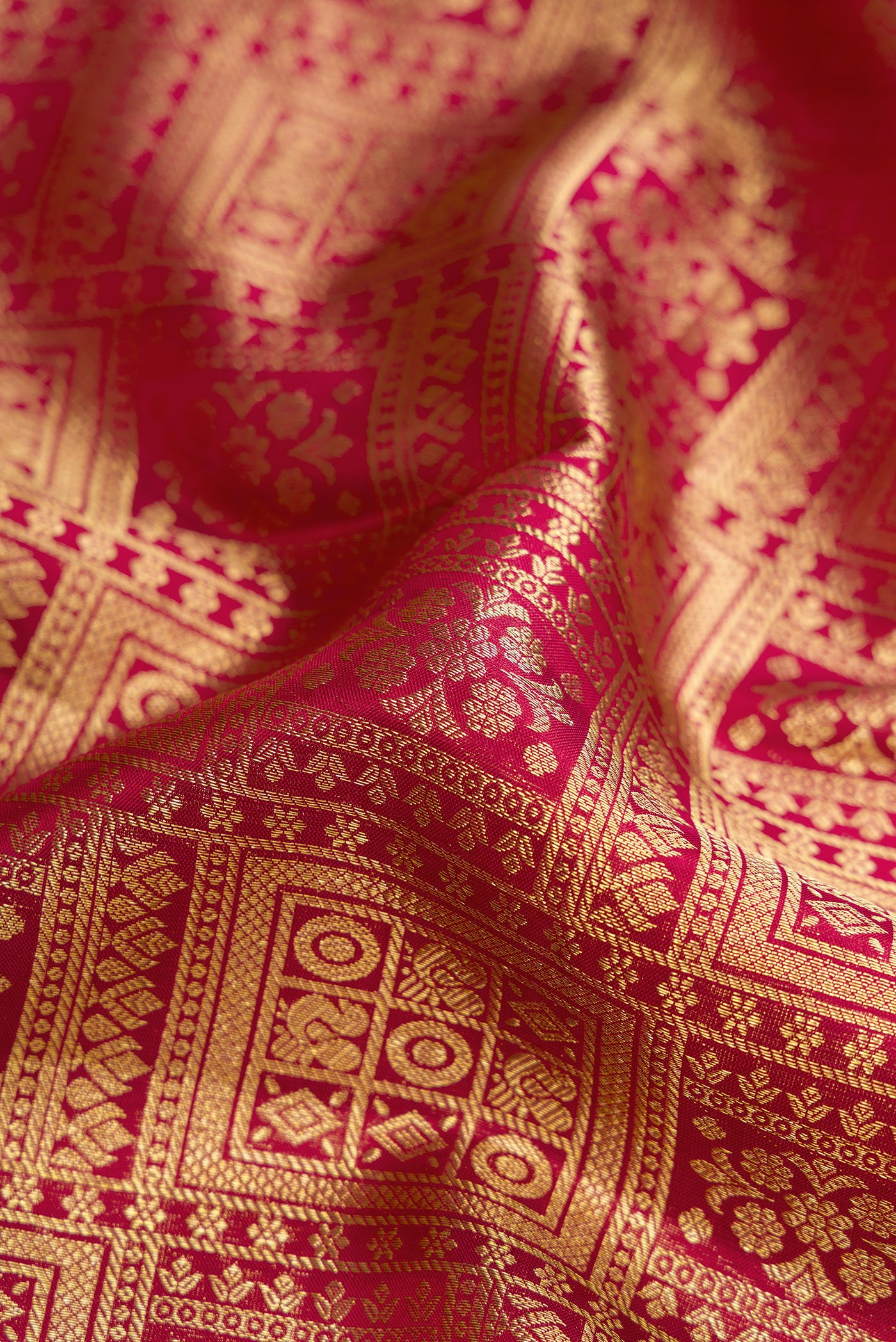 Close up of Maroon Kanjivaram Silk Saree with Zari Brocade on the body and Zari Border.  displaying folds
