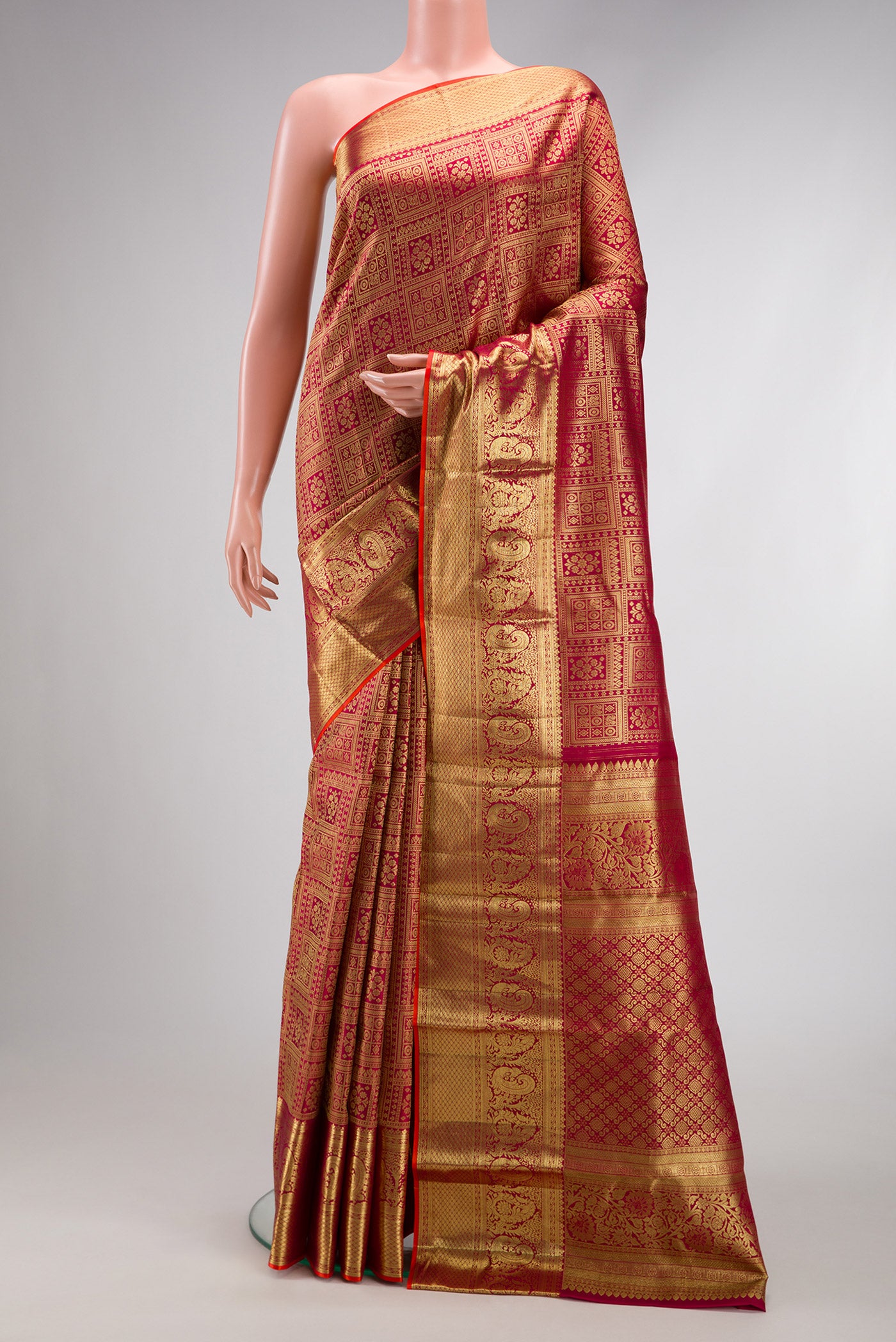 Maroon Kanjivaram Silk Saree with Zari Brocade on the body and Zari Border.  displayed on a mannequin