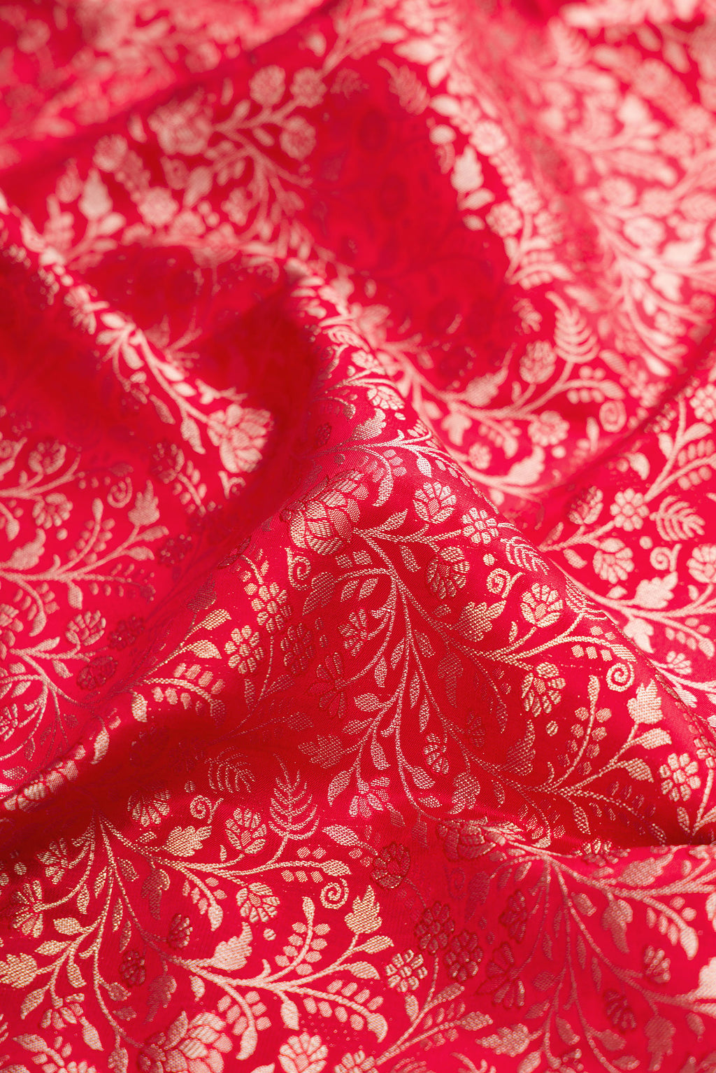 Close up of Red Kanjivaram Silk Saree with Zari Brocade on the body and Fancy Border.  displaying folds