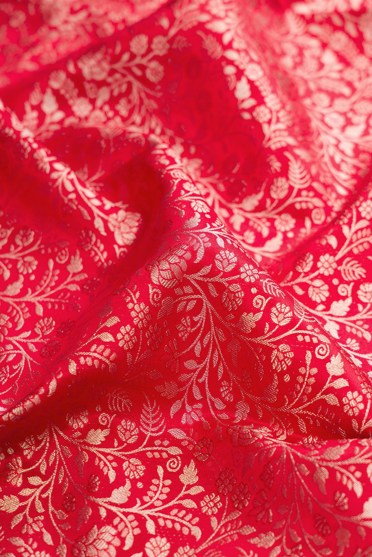 Close up of Red Kanjivaram Silk Saree with Zari Brocade on the body and Fancy Border.  displaying folds