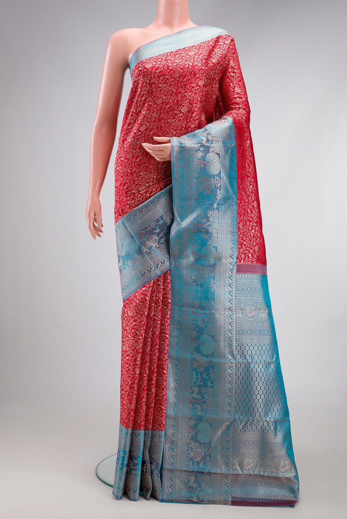 Red Kanjivaram Silk Saree with Zari Brocade on the body and Fancy Border.  displayed on a mannequin