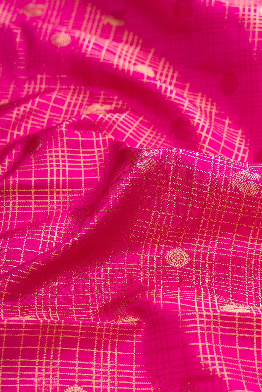 Close up of Pink Dual Tone Kanjivaram Silk Saree with Checked design on the body and Zari Border.  displaying folds