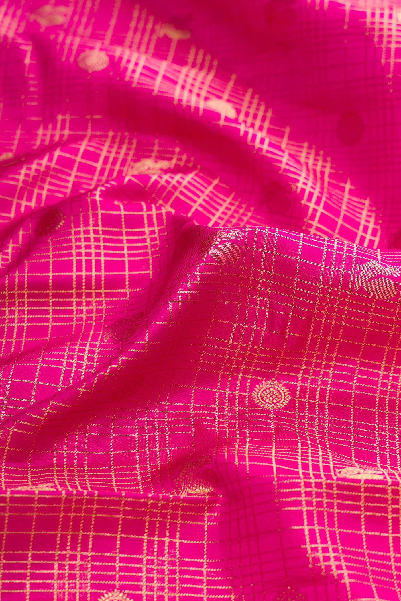 Close up of Pink Dual Tone Kanjivaram Silk Saree with Checked design on the body and Zari Border.  displaying folds