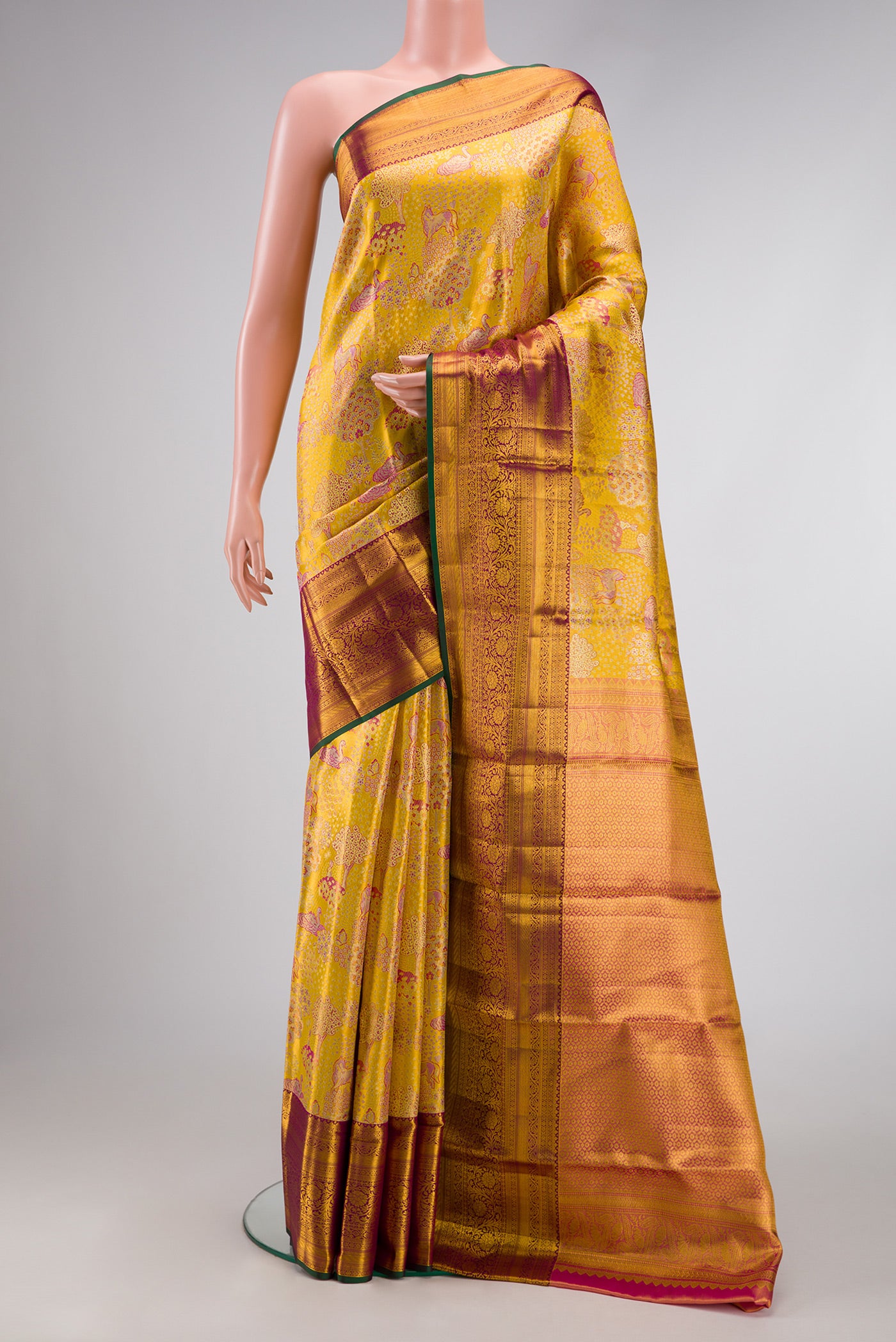 Gold Dual Tone Kanjivaram Tissue Silk Saree with Zari Brocade on the body and Zari Border.  displayed on a mannequin
