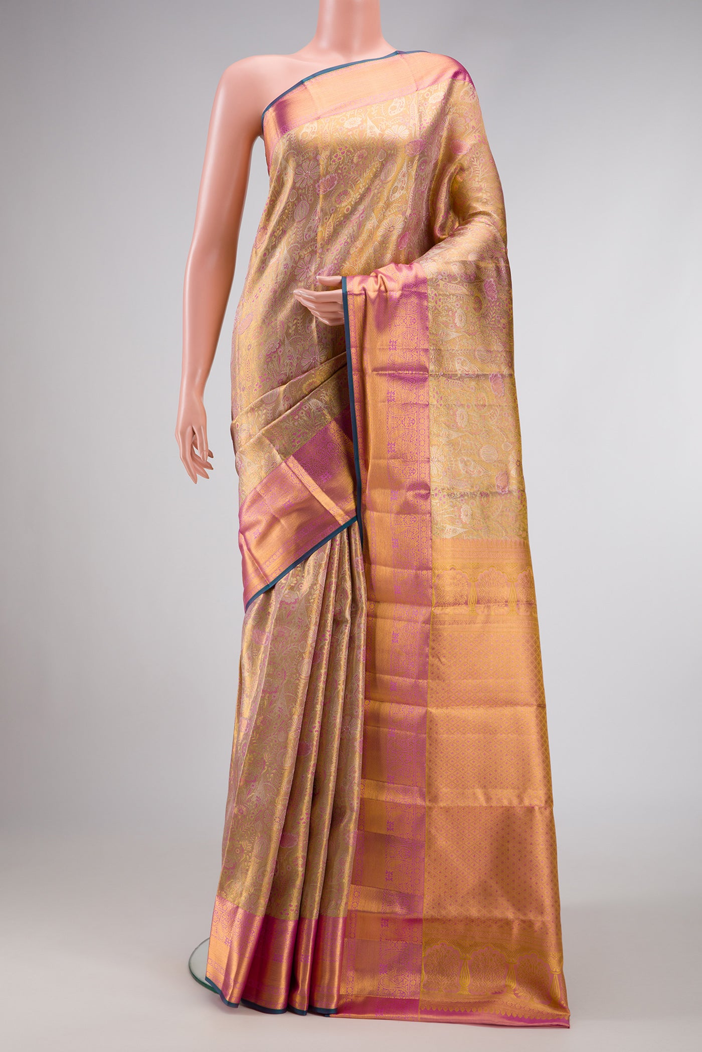 Gold Dual Tone Kanjivaram Tissue Silk Saree with Zari Brocade on the body and Zari Border.  displayed on a mannequin