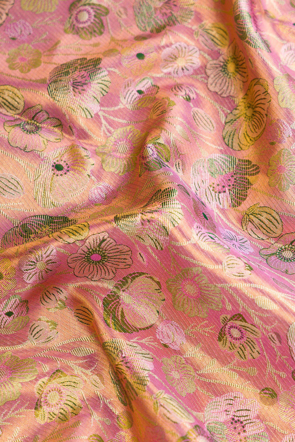 Close up of Pink Dual Tone Kanjivaram Tissue Silk Saree with Zari Brocade on the body and Zari Border.  displaying folds