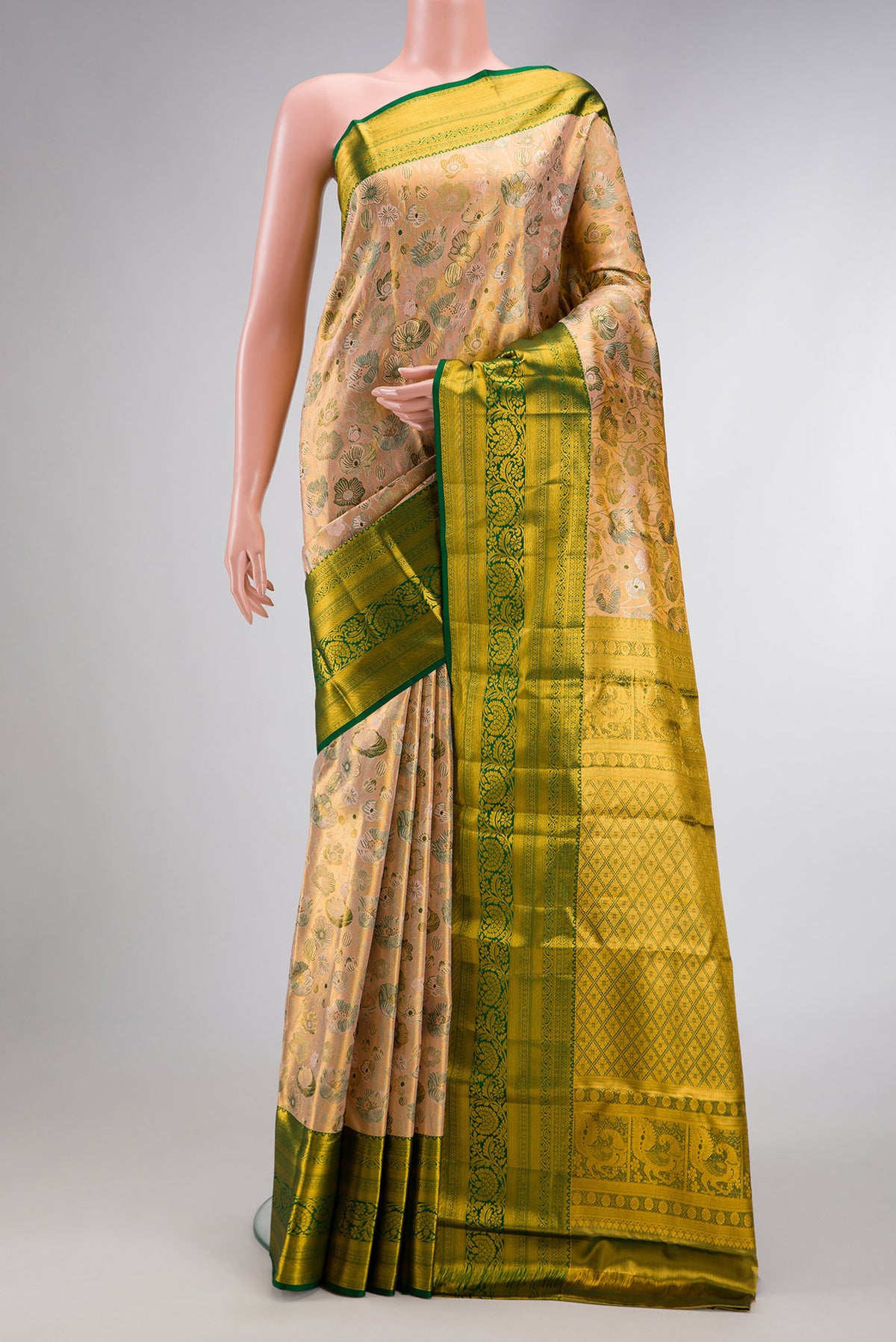 Peach Dual Tone Kanjivaram Tissue Silk Saree with Zari Brocade on the body and Zari Border.  displayed on a mannequin