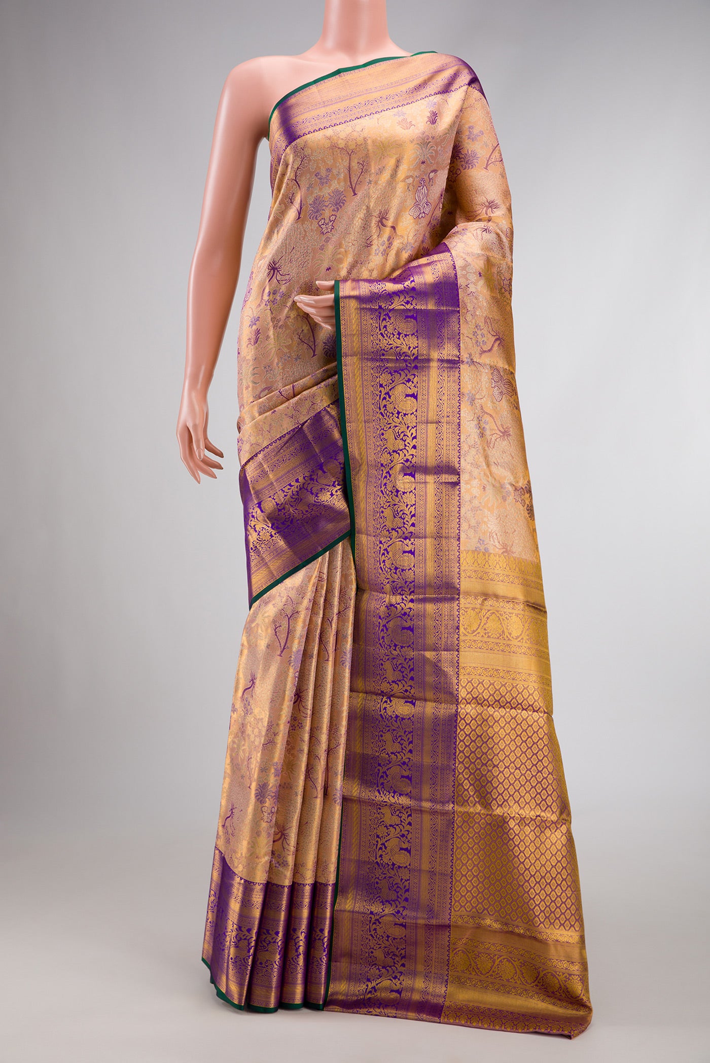 Golden Peach Dual Tone Kanjivaram Tissue Silk Saree with Zari Brocade on the body and Zari Border.  displayed on a mannequin