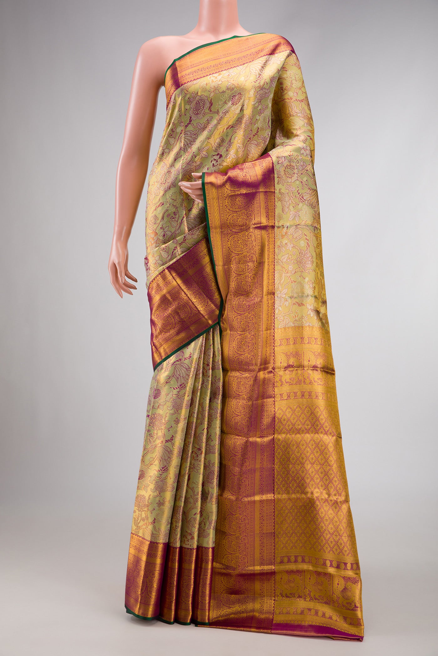 Pista Green Dual Tone Kanjivaram Tissue Silk Saree with Zari Brocade on the body and Zari Border.  displayed on a mannequin