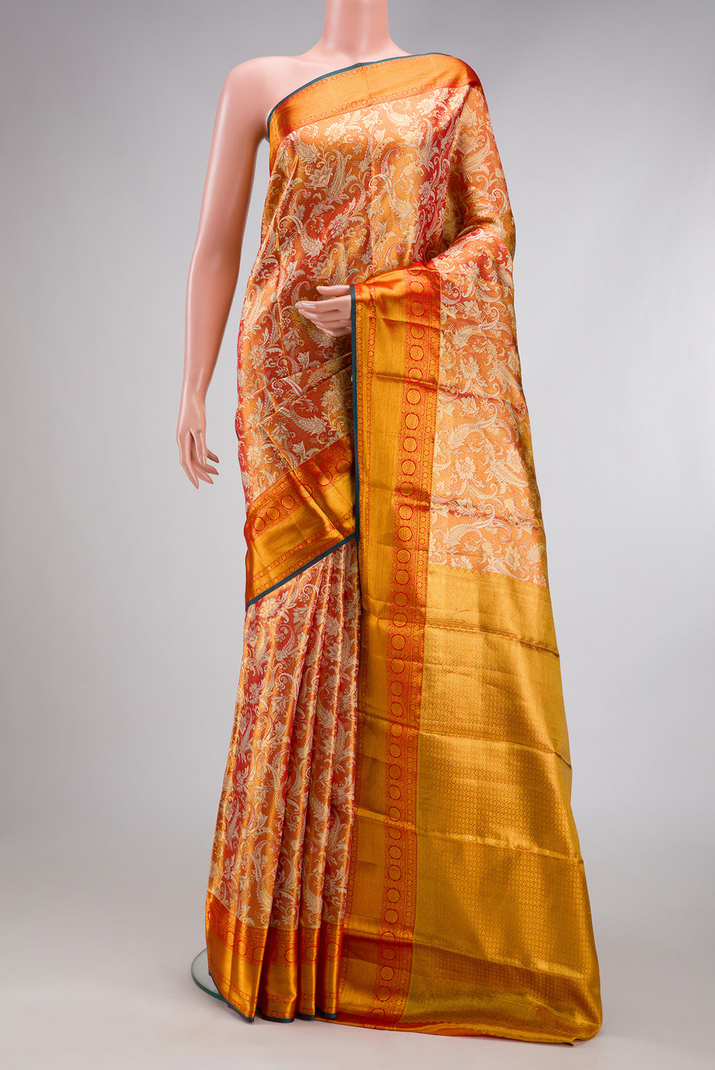 Orange Dual Tone Kanjivaram Tissue Silk Saree with Zari Brocade on the body and Fancy Border.  displayed on a mannequin