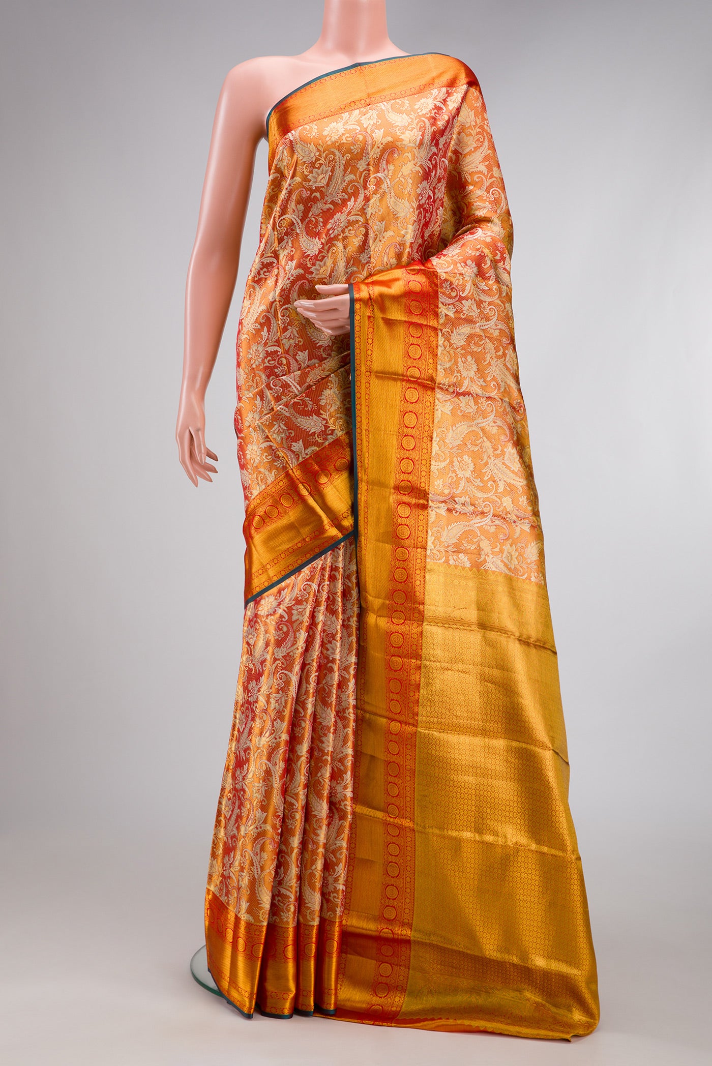 Orange Dual Tone Kanjivaram Tissue Silk Saree with Zari Brocade on the body and Fancy Border.  displayed on a mannequin