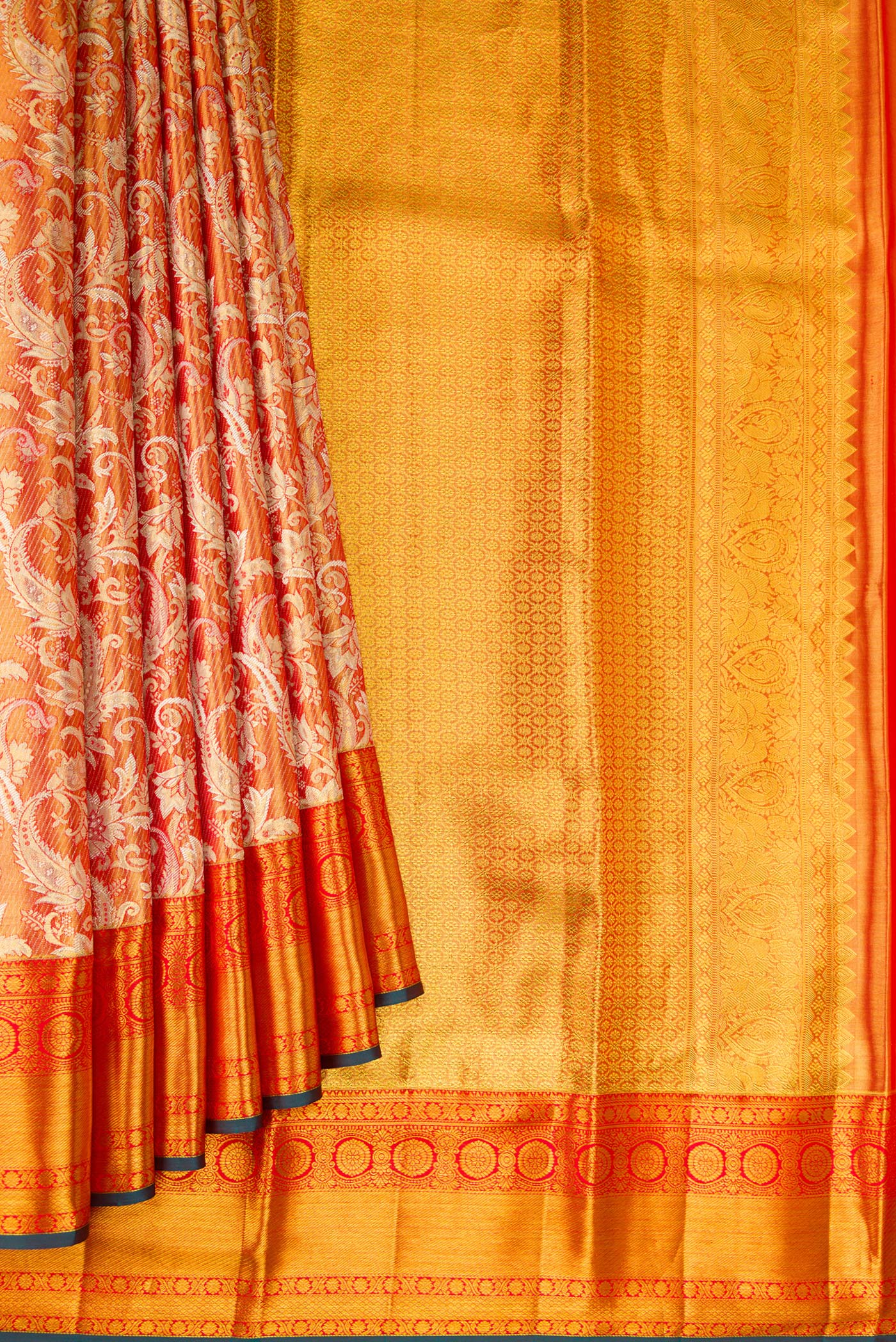 Pleats and pallu of Orange Dual Tone Kanjivaram Tissue Silk Saree with Zari Brocade on the body and Fancy Border. 