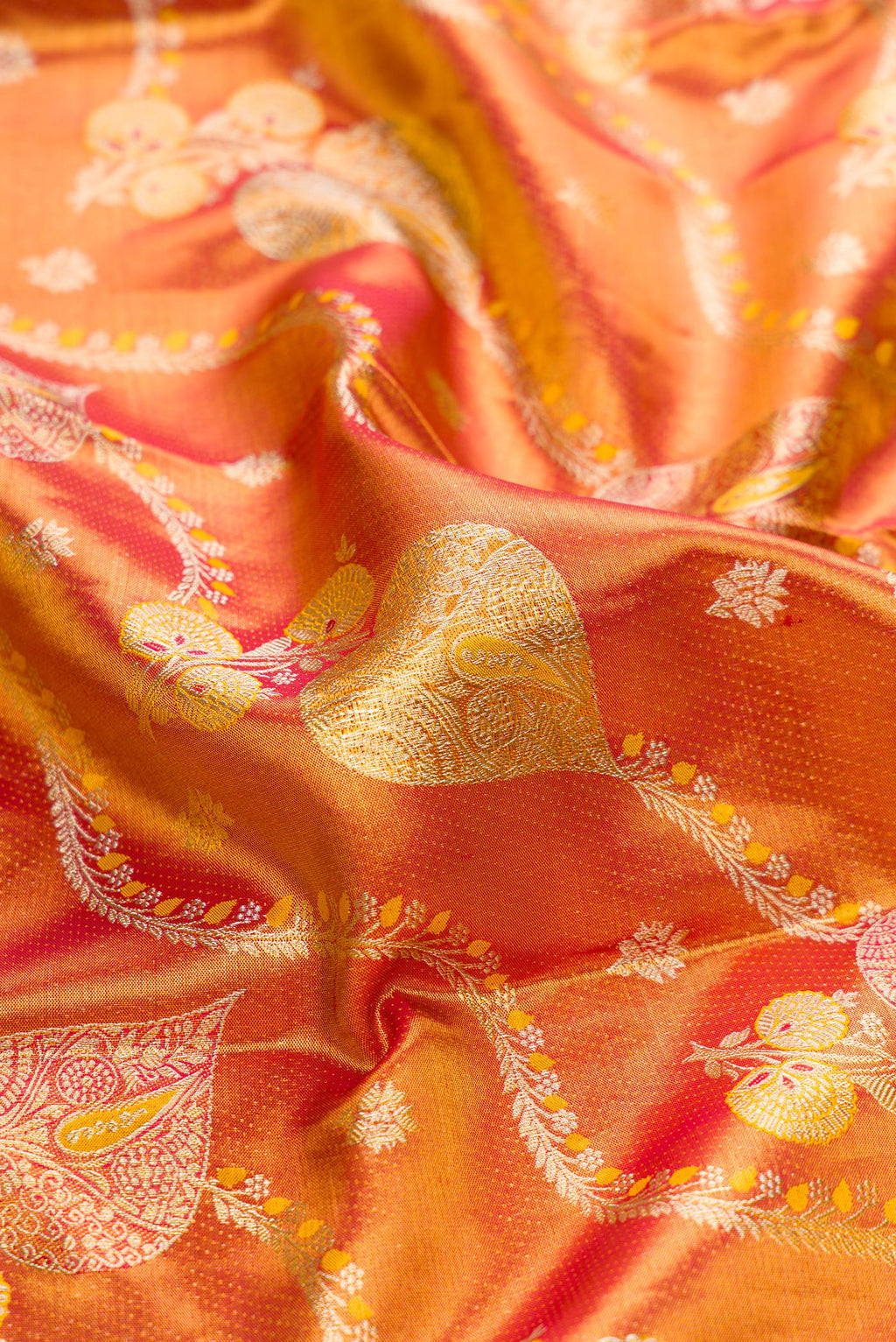 Close up of Red Dual Tone Kanjivaram Tissue Silk Saree with Zari Brocade on the body and Zari Border.  displaying folds