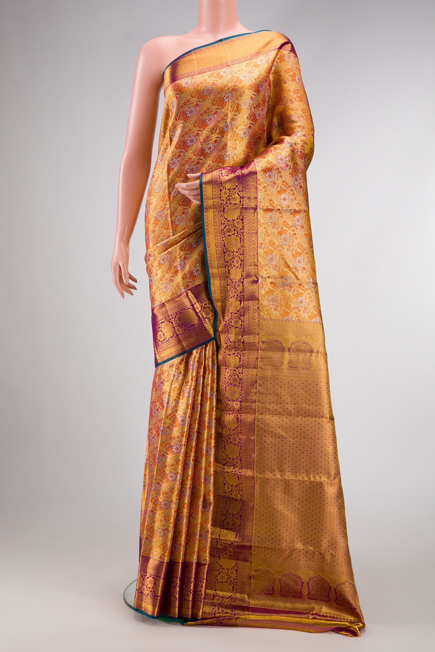 Gold Dual Tone Kanjivaram Tissue Silk Saree with Zari Brocade on the body and Zari Border.  displayed on a mannequin