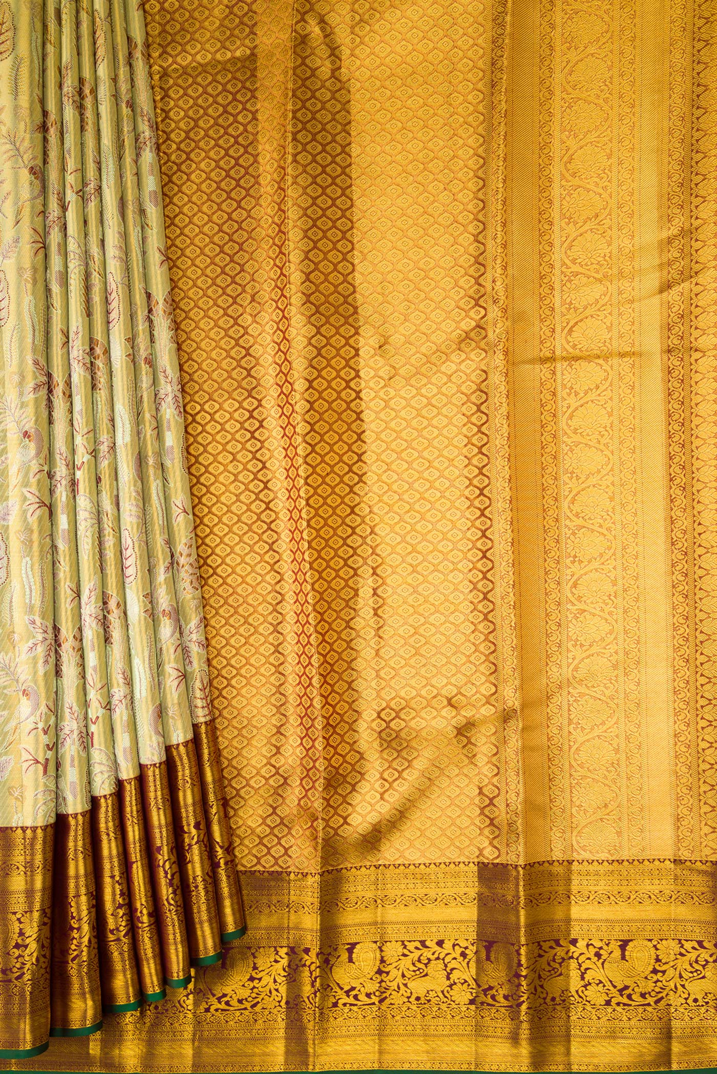 Pleats and pallu of Gold Dual Tone Kanjivaram Tissue Silk Saree with Zari Brocade on the body and Zari Border. 