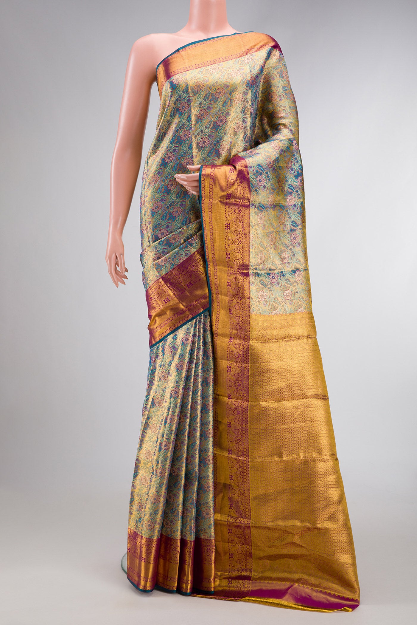 Gold Dual Tone Kanjivaram Tissue Silk Saree with Zari Brocade on the body and Zari Border.  displayed on a mannequin