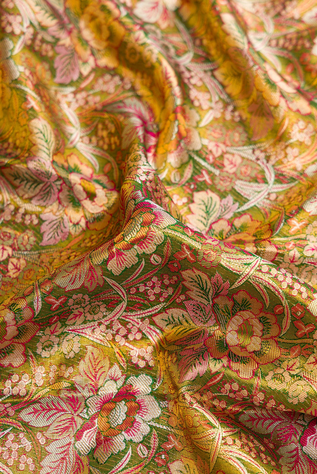 Close up of Mehandi Green Dual Tone Kanjivaram Tissue Silk Saree with Zari Brocade on the body and Zari Border.  displaying folds