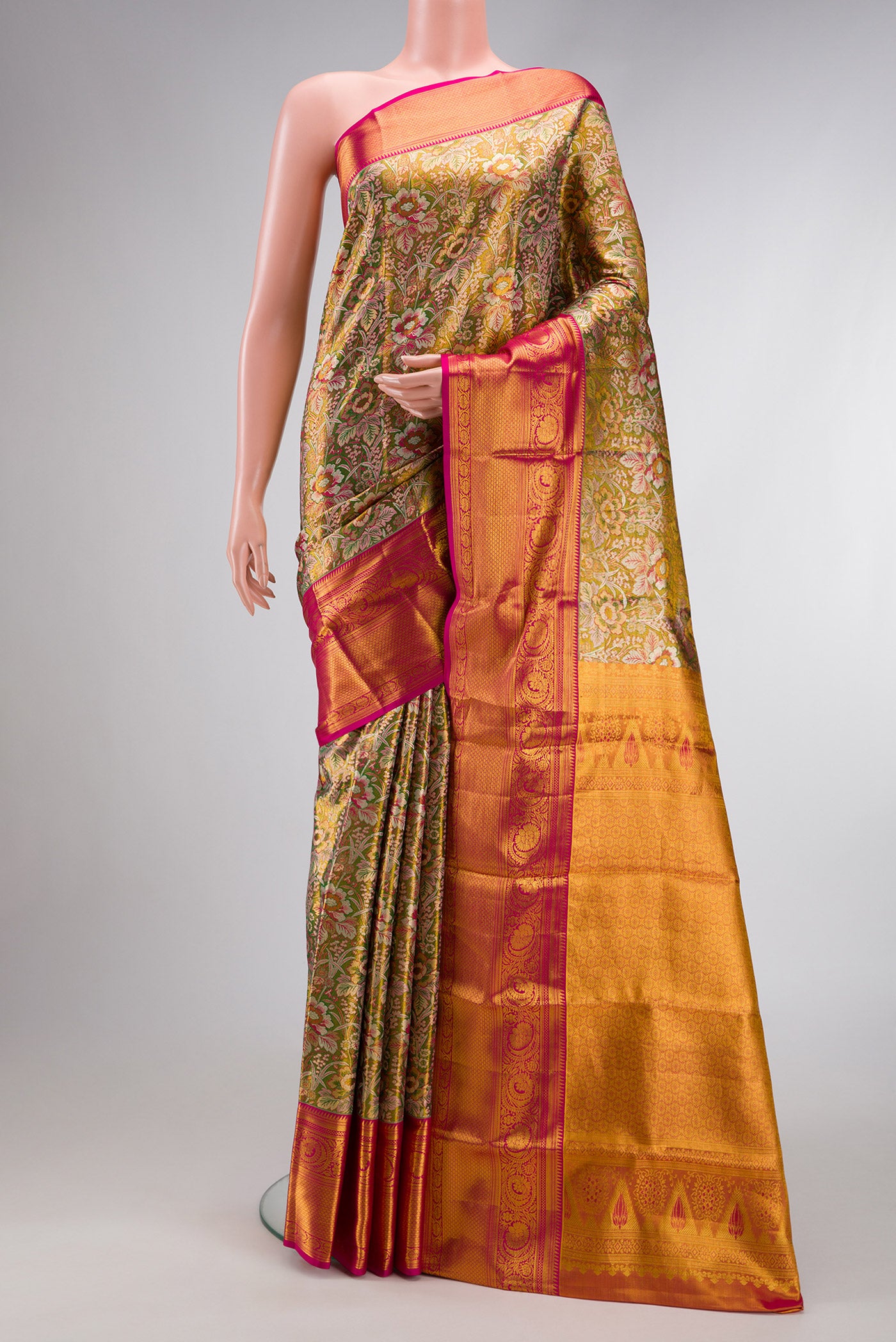 Mehandi Green Dual Tone Kanjivaram Tissue Silk Saree with Zari Brocade on the body and Zari Border.  displayed on a mannequin