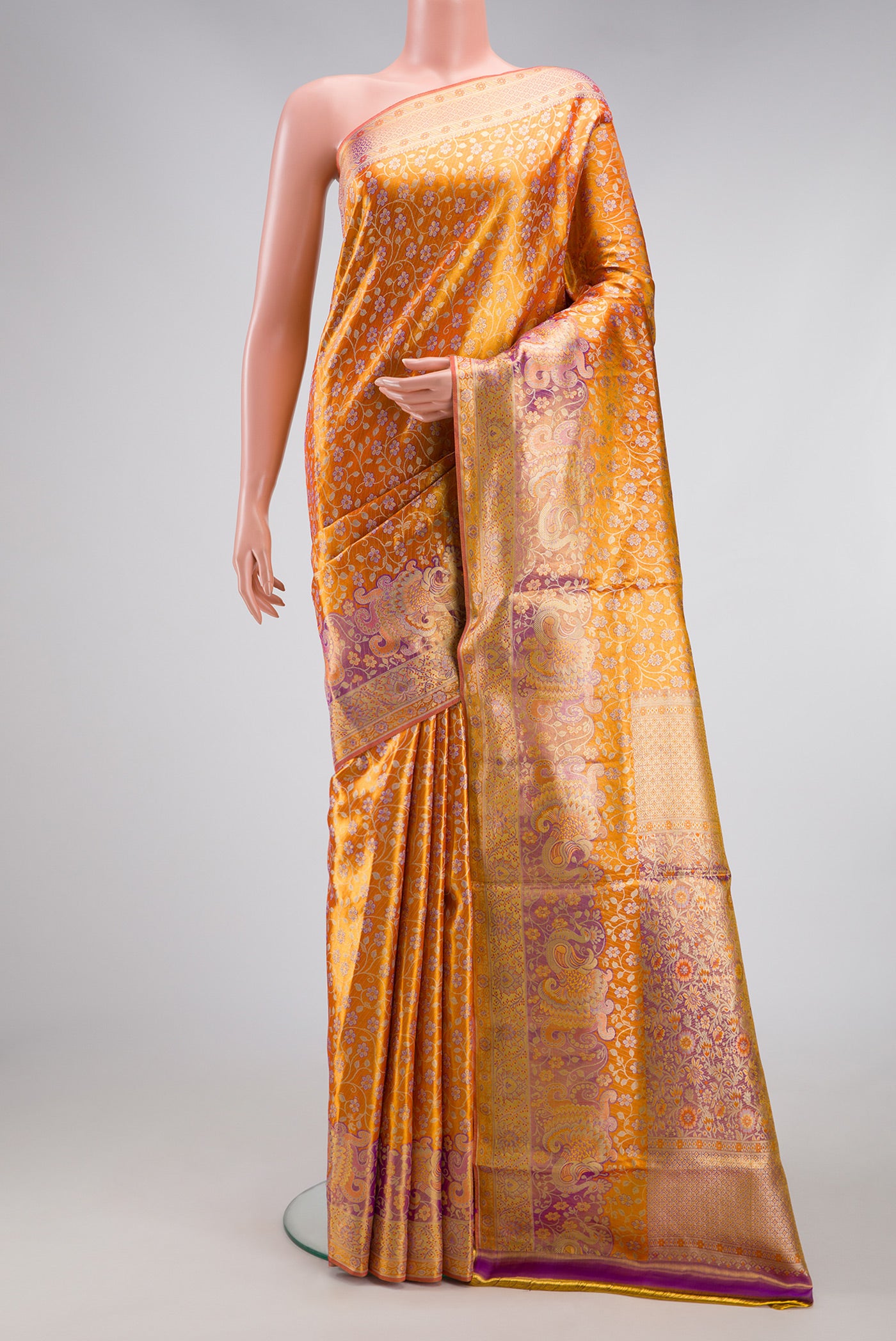 Golden Peach Dual Tone Kanjivaram Tissue Silk Saree with Zari Brocade on the body and Fancy Border.  displayed on a mannequin