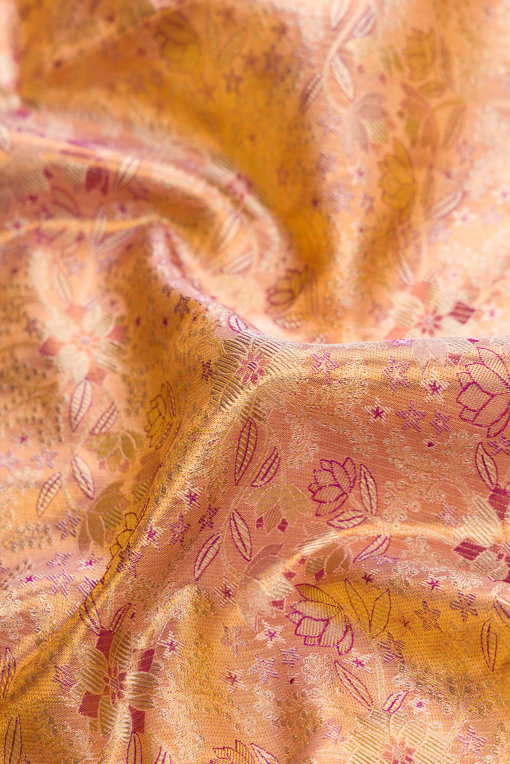 Close up of Gold Dual Tone Kanjivaram Tissue Silk Saree with Zari Brocade on the body and Zari Border.  displaying folds