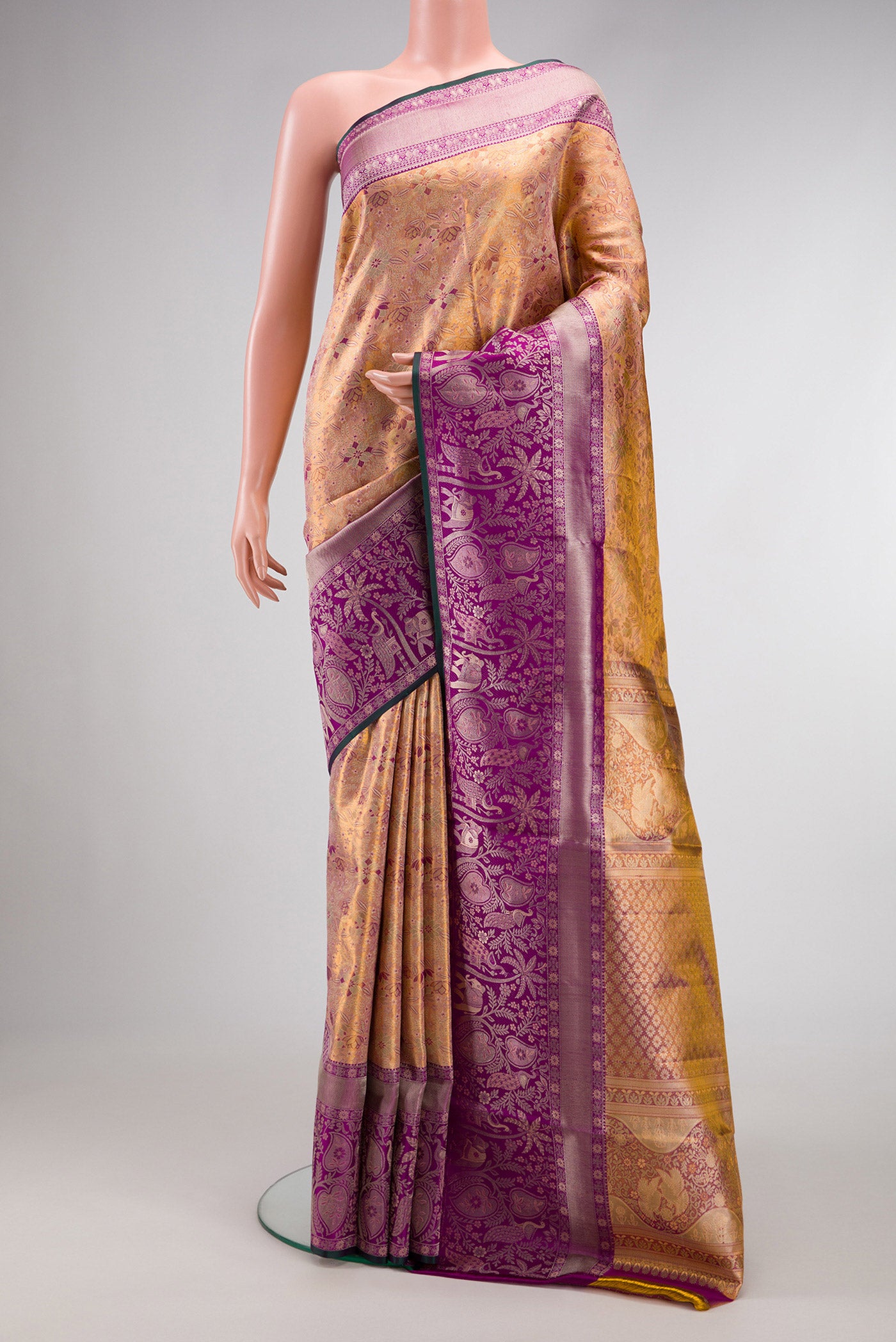 Gold Dual Tone Kanjivaram Tissue Silk Saree with Zari Brocade on the body and Zari Border.  displayed on a mannequin